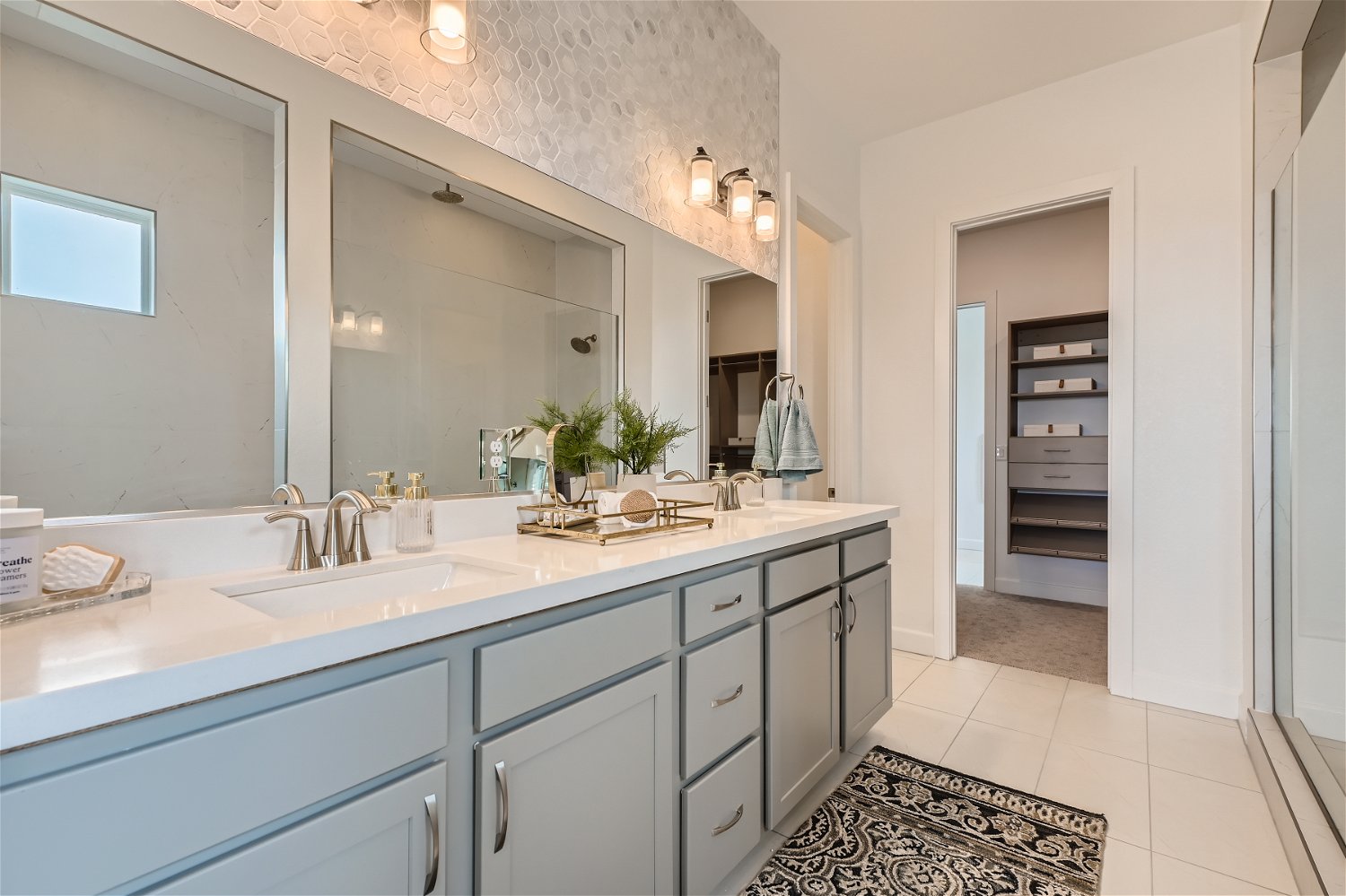 A bathroom with a large mirror.