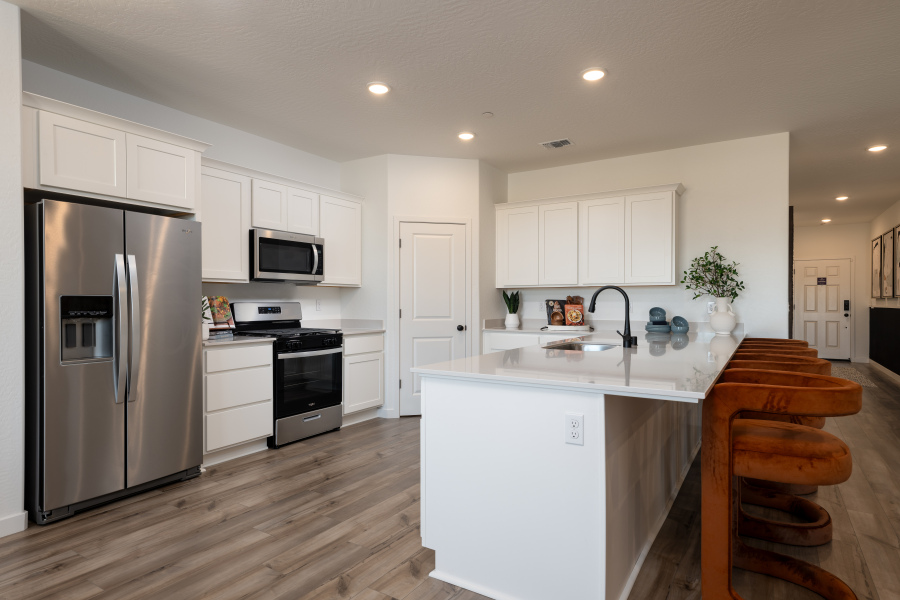 A kitchen with white cabinets.
