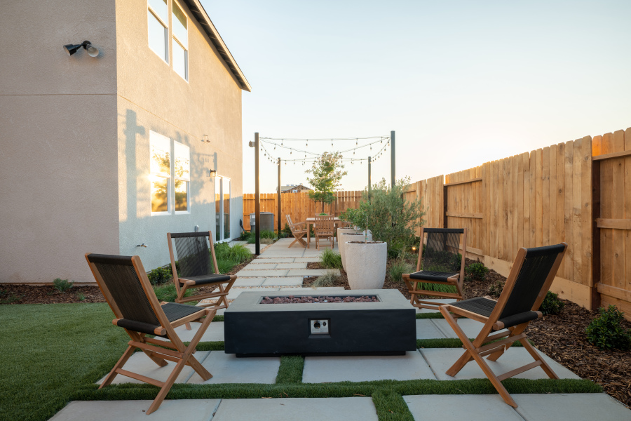 A deck with chairs and a table.