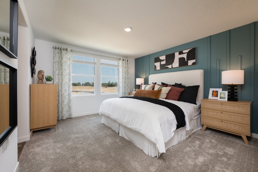 A bedroom with a bed and a window.