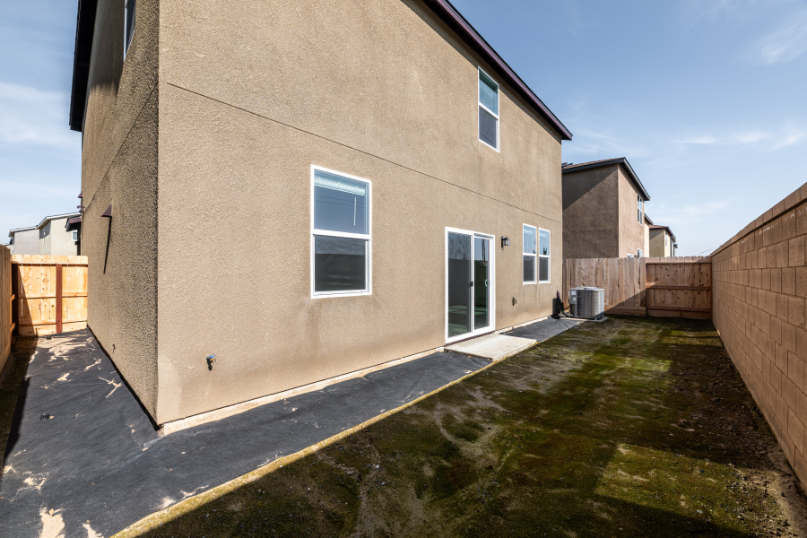 A building with a fence and grass.