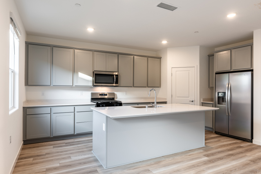 A kitchen with white cabinets.