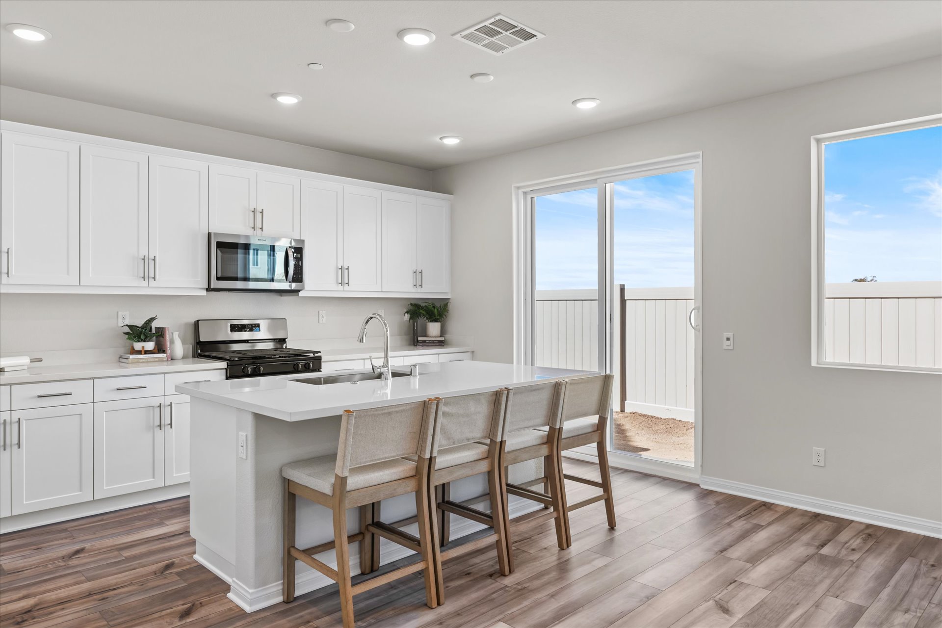 A kitchen with white cabinets.