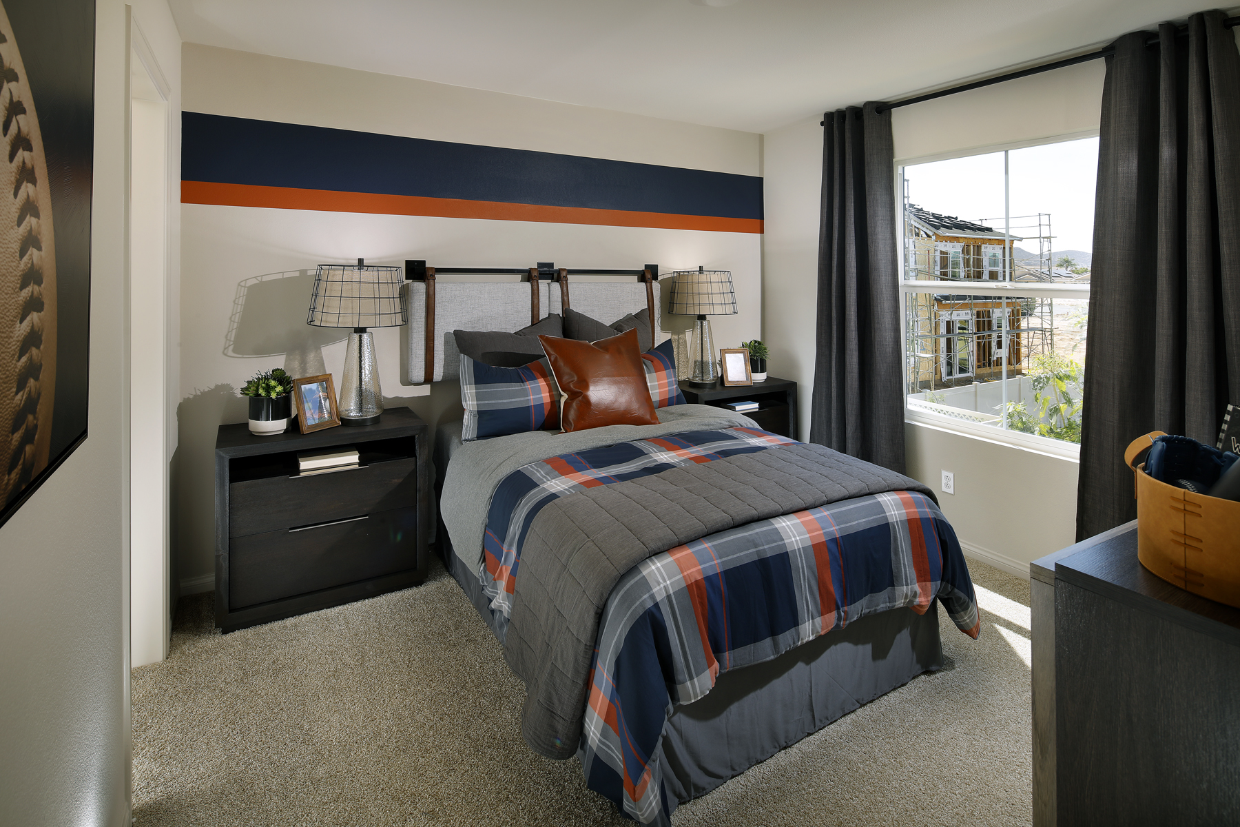 A bedroom with a bed and a window.