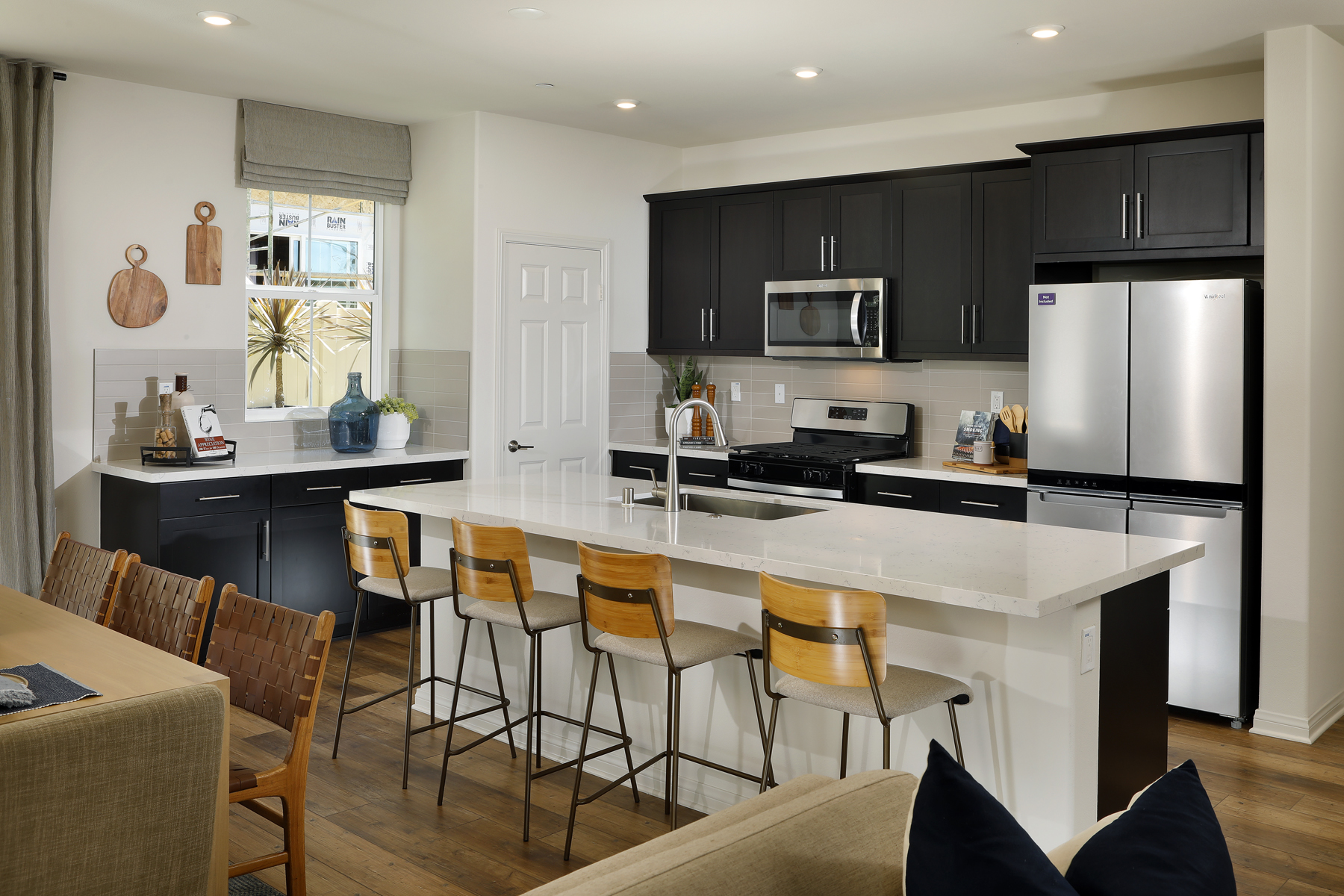 A kitchen with black cabinets.