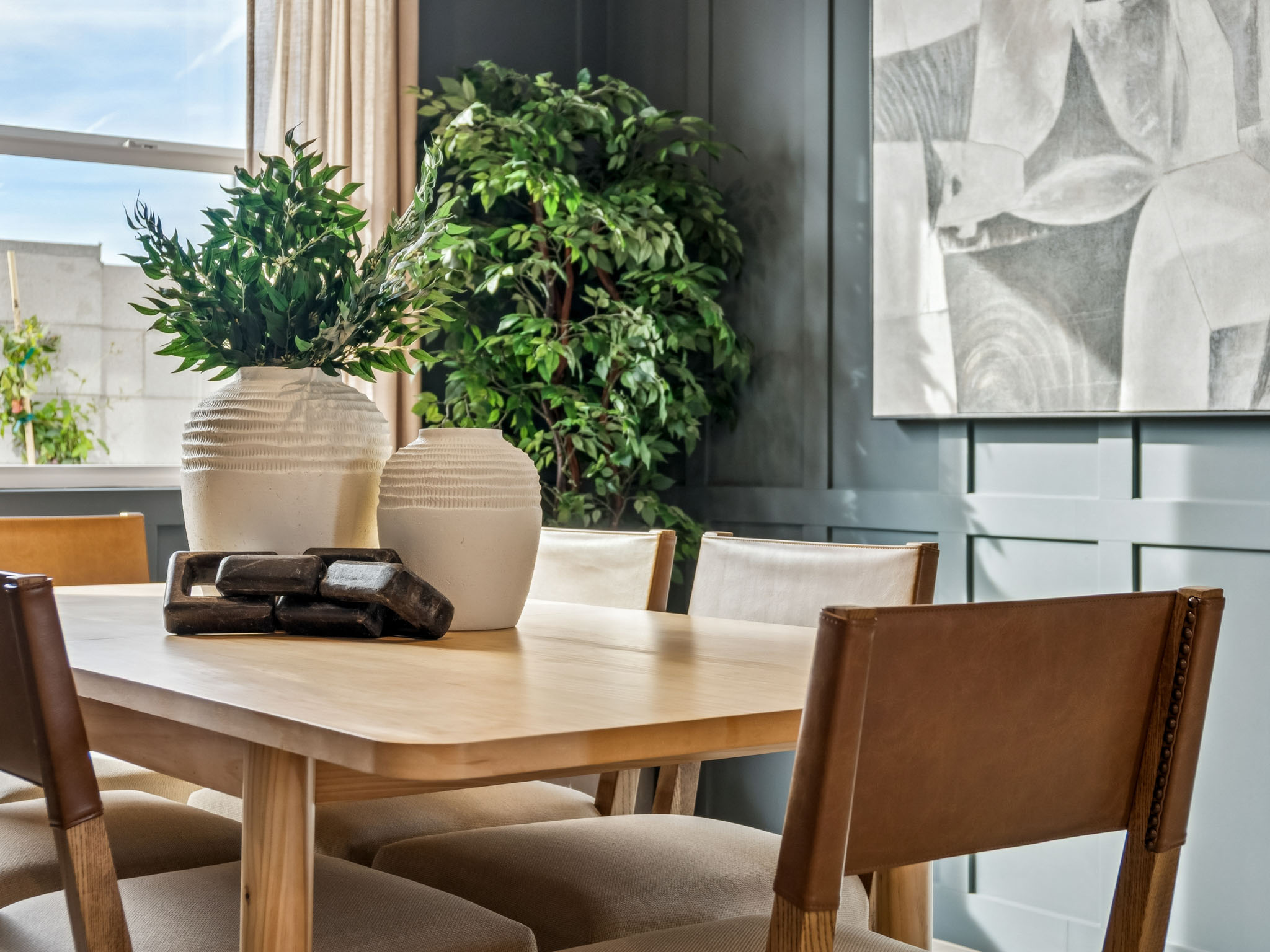 A table with chairs and a plant on it.