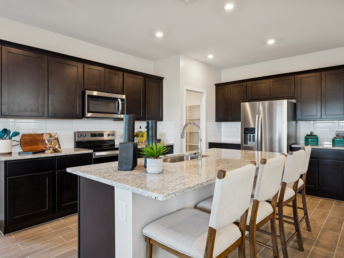 A kitchen with a marble island.
