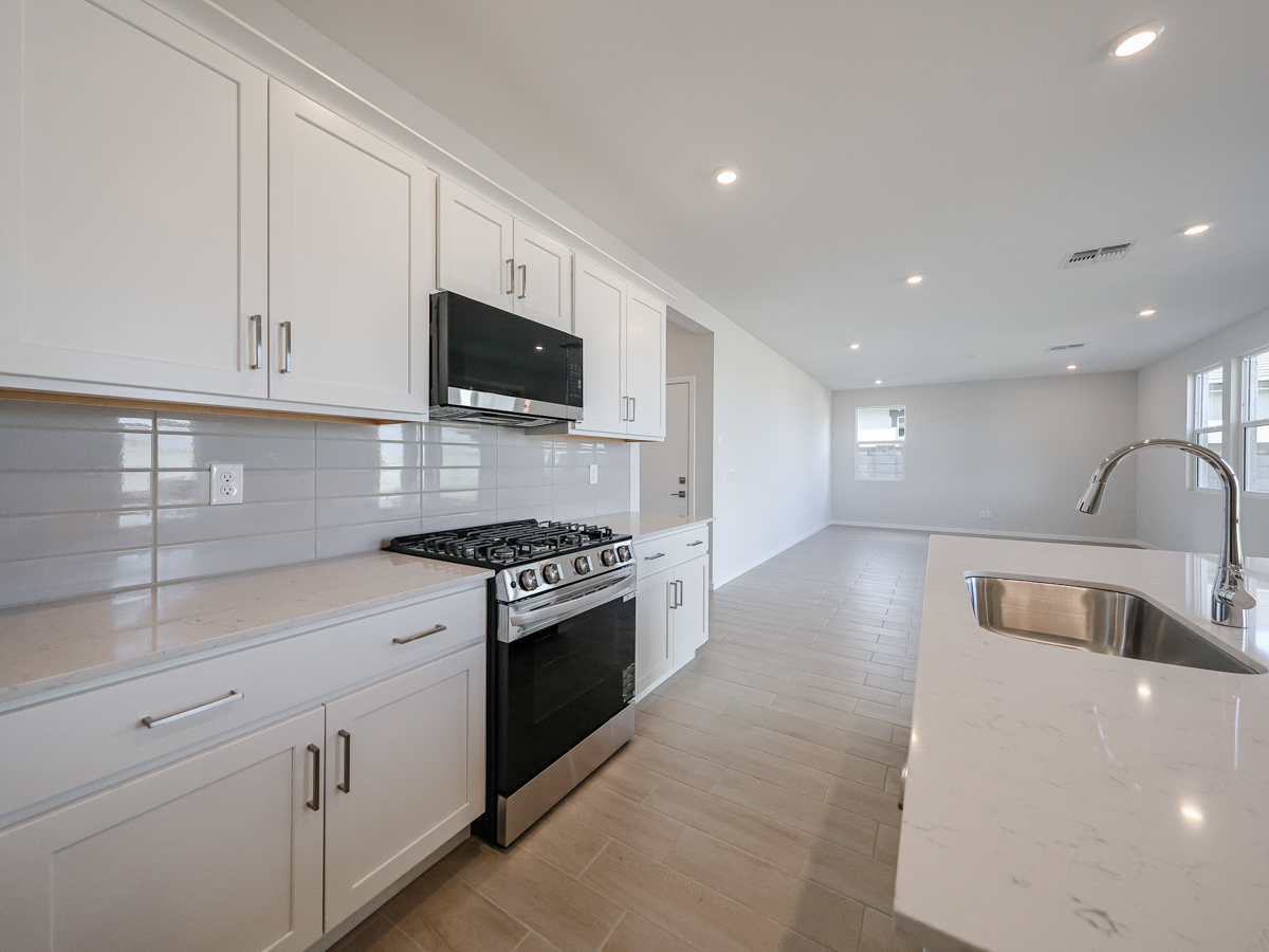 A kitchen with white cabinets.