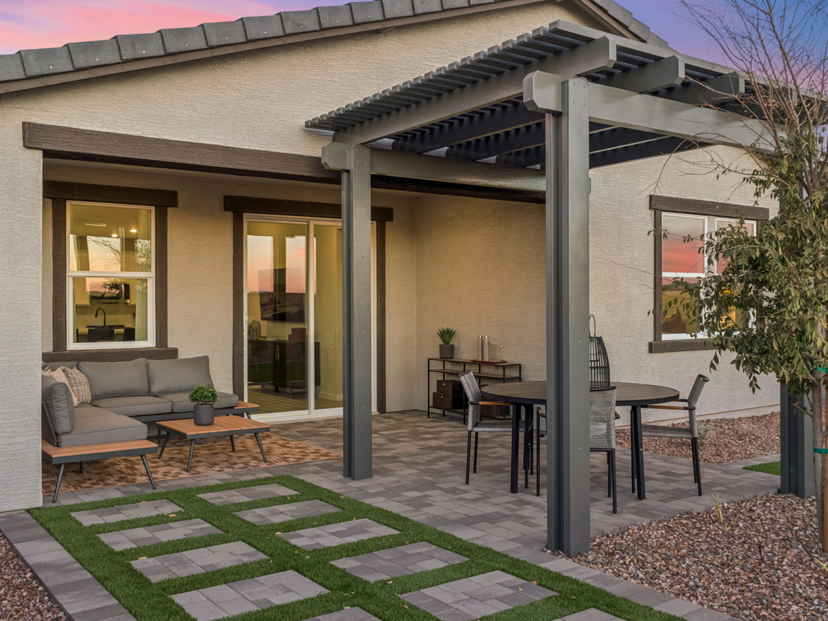 A house with a patio and a table and chairs.