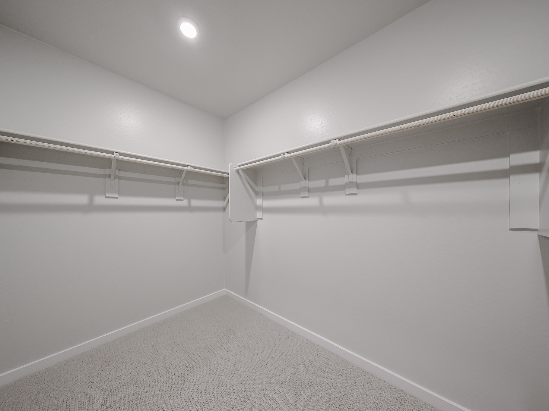 A white room with a metal railing.