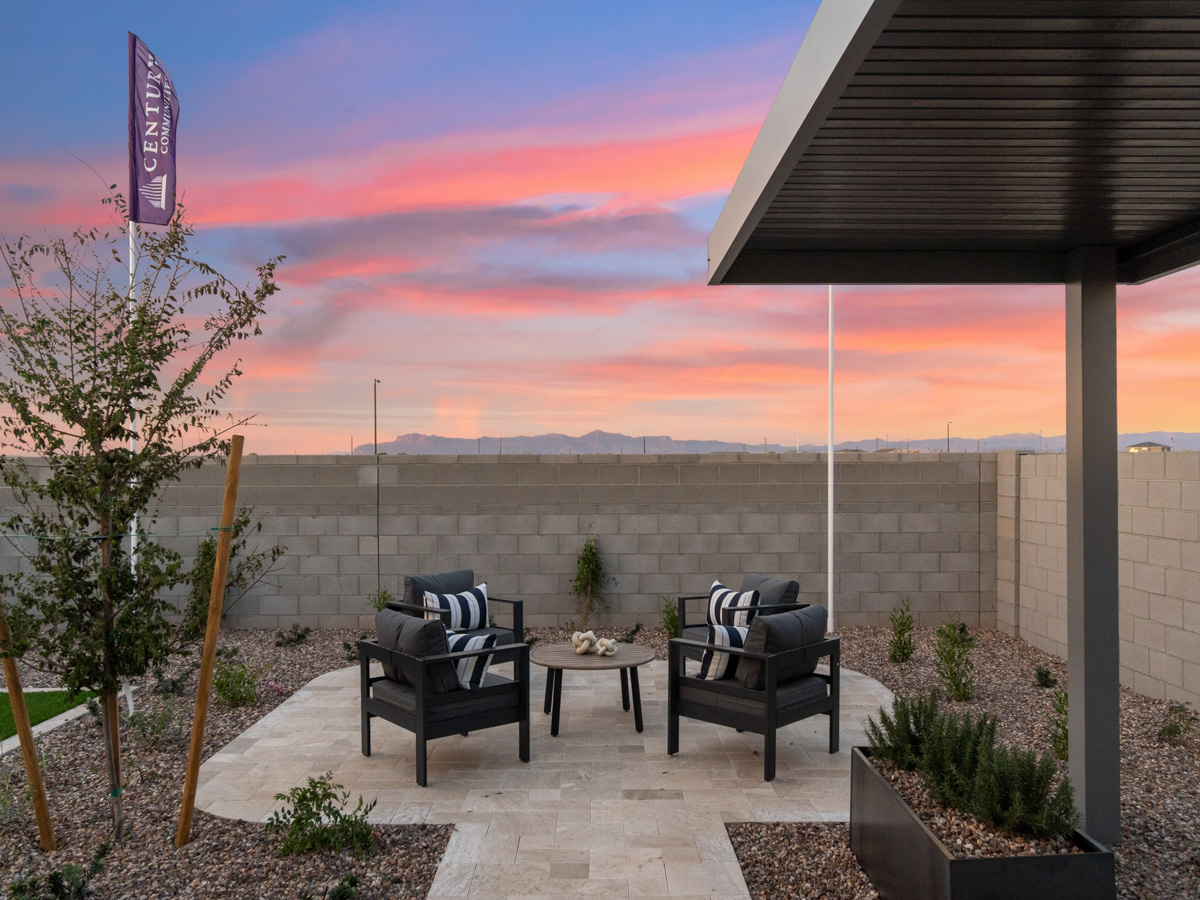 A patio with chairs and a table.