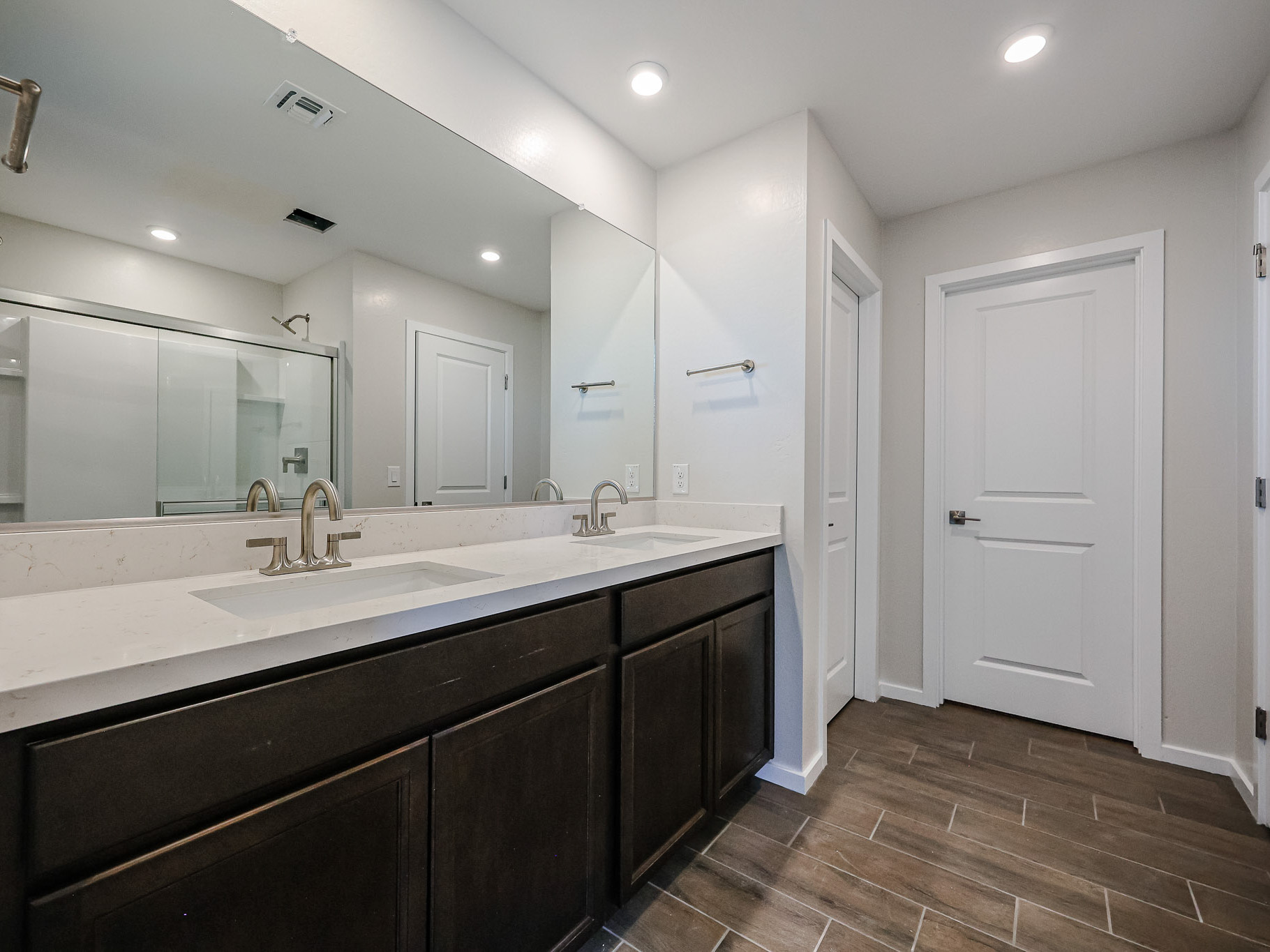 A bathroom with a large mirror.