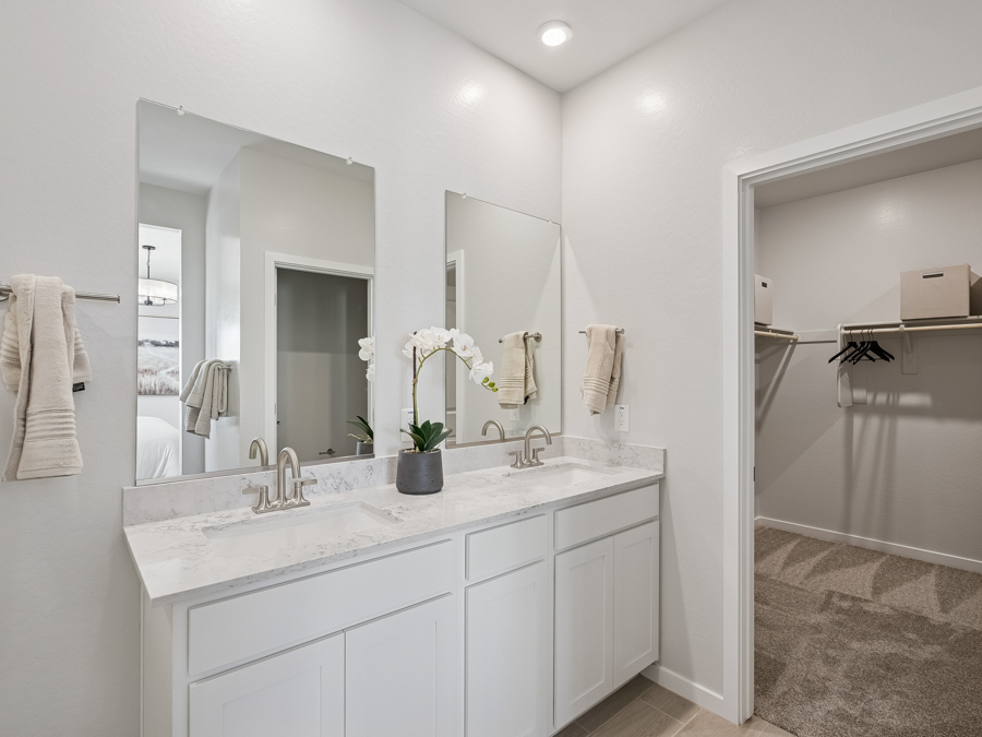 A bathroom with a tub sink and mirror.