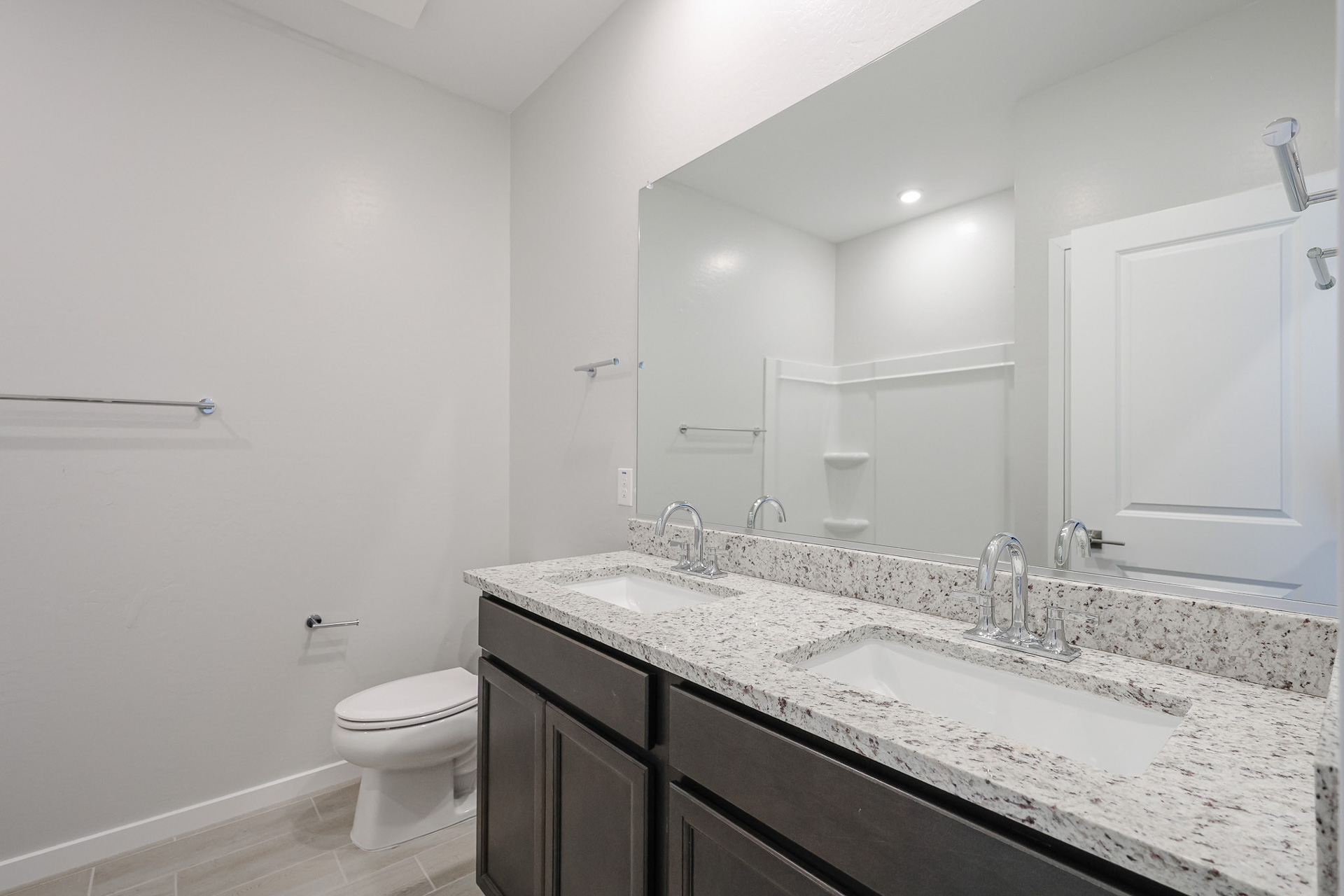 A bathroom with a large mirror.