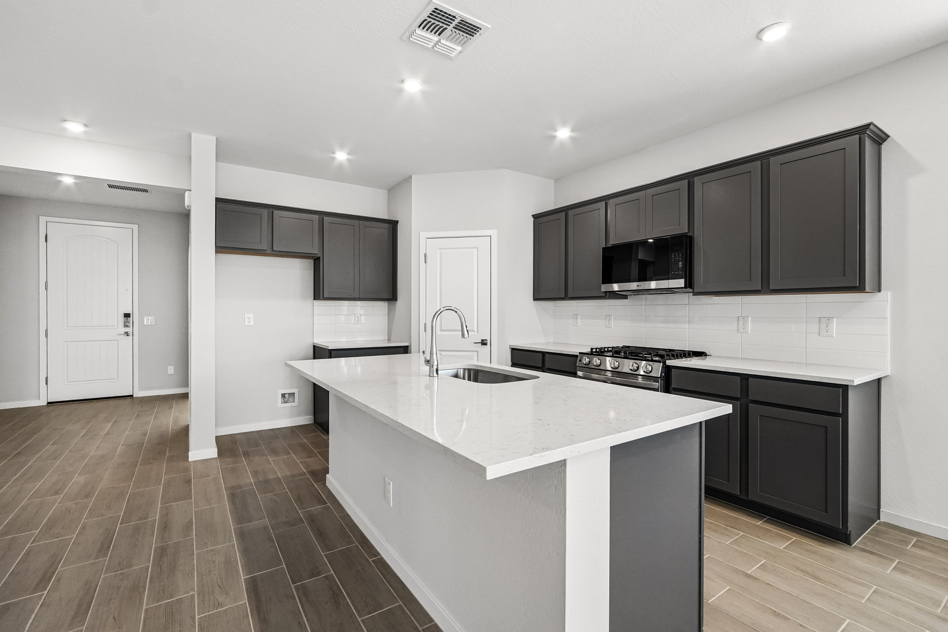 A kitchen with black cabinets.