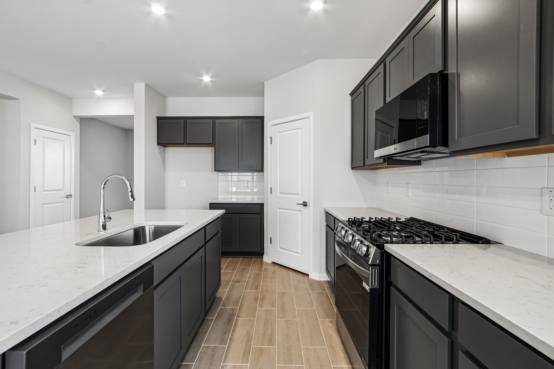 A kitchen with black cabinets.