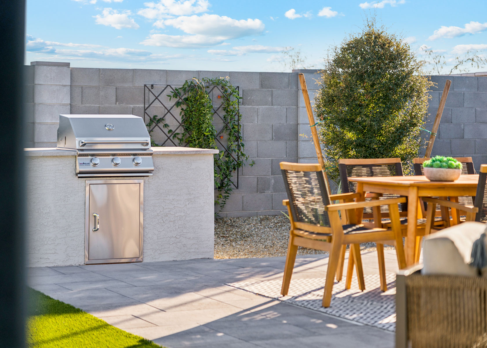 A patio with a table and chairs.