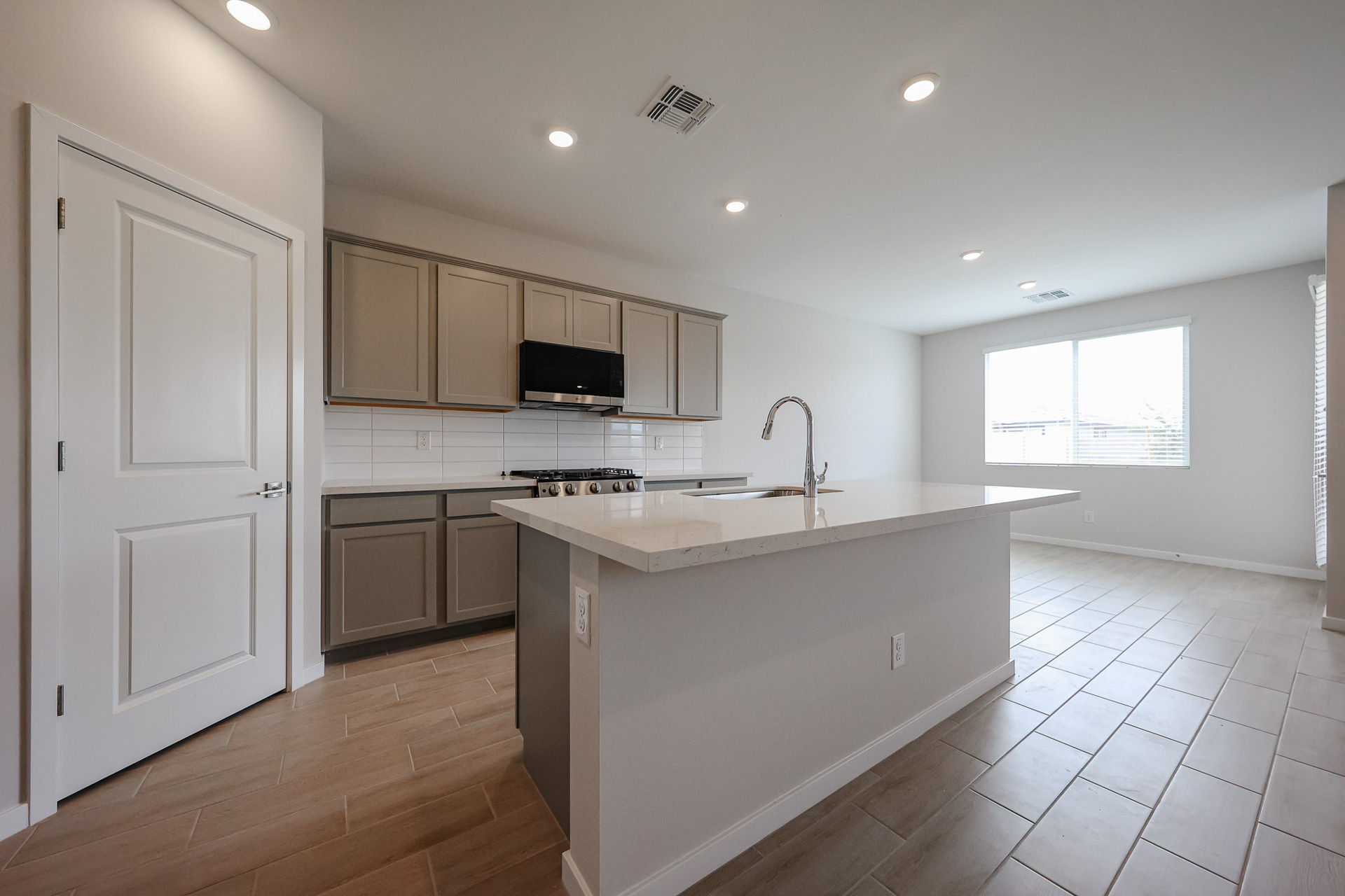 A kitchen with white cabinets.