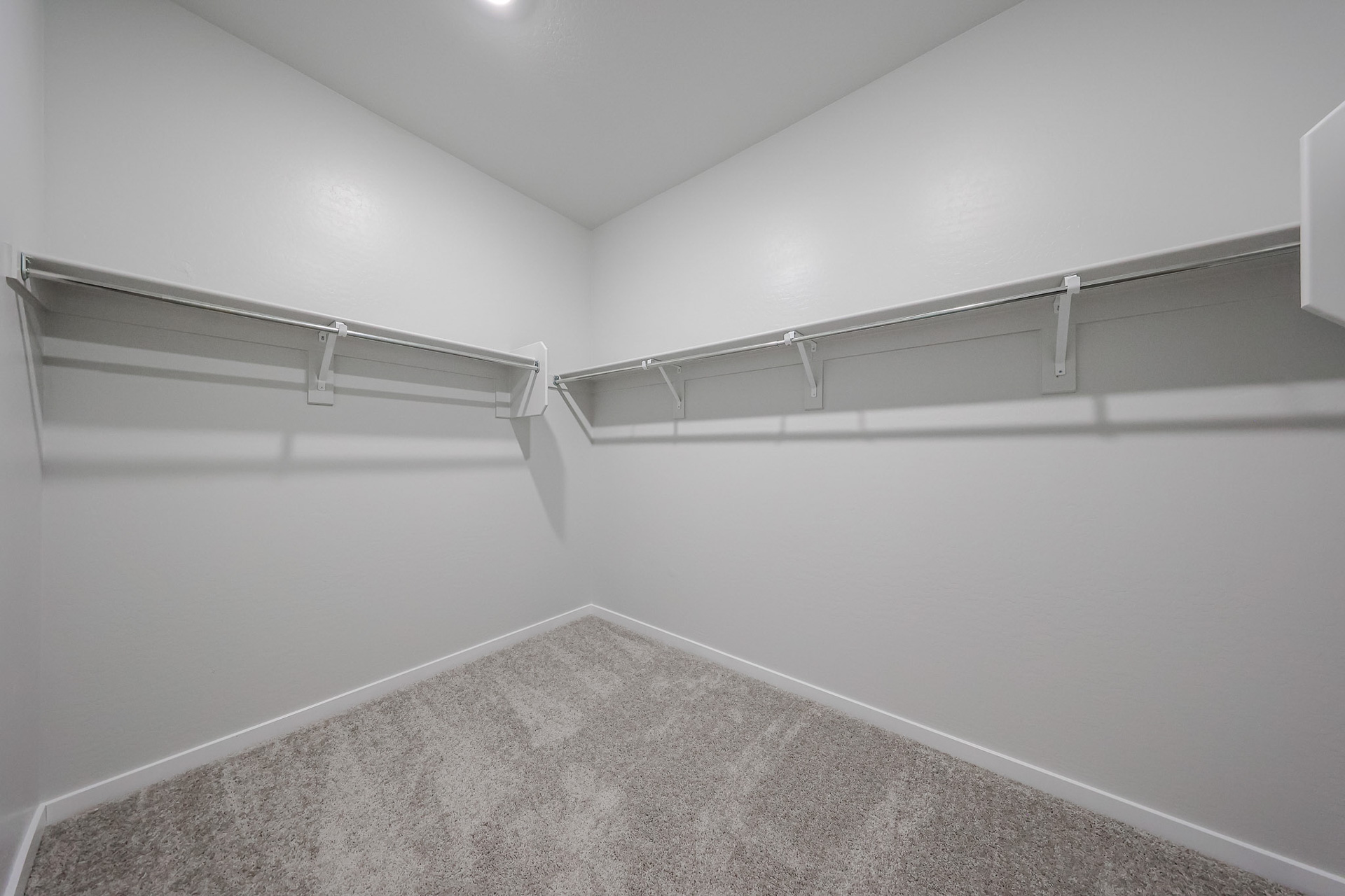 A white wall with a metal railing.