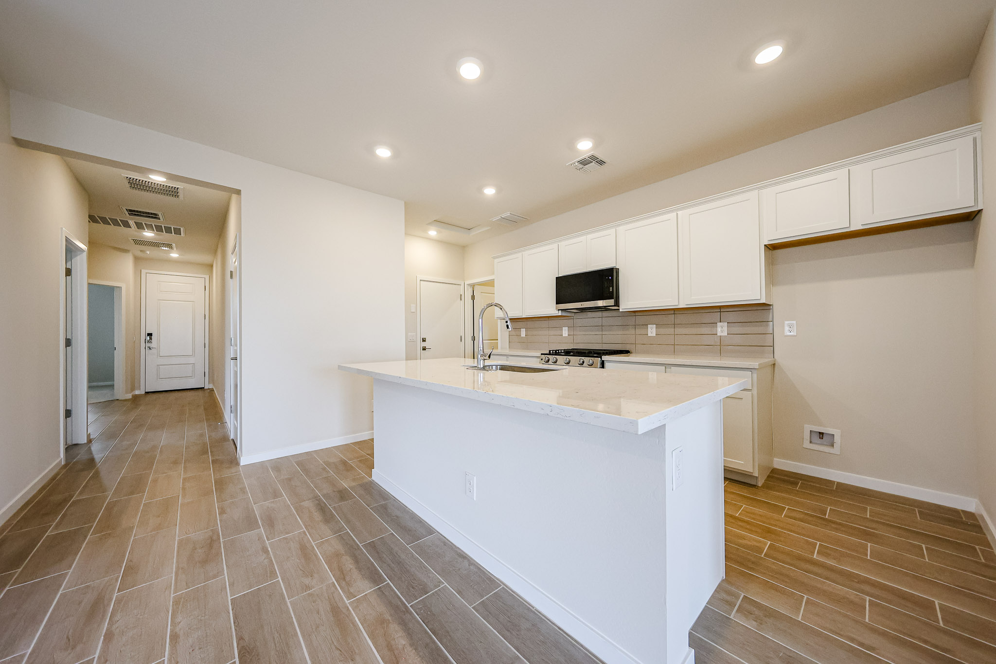 A kitchen with white cabinets.