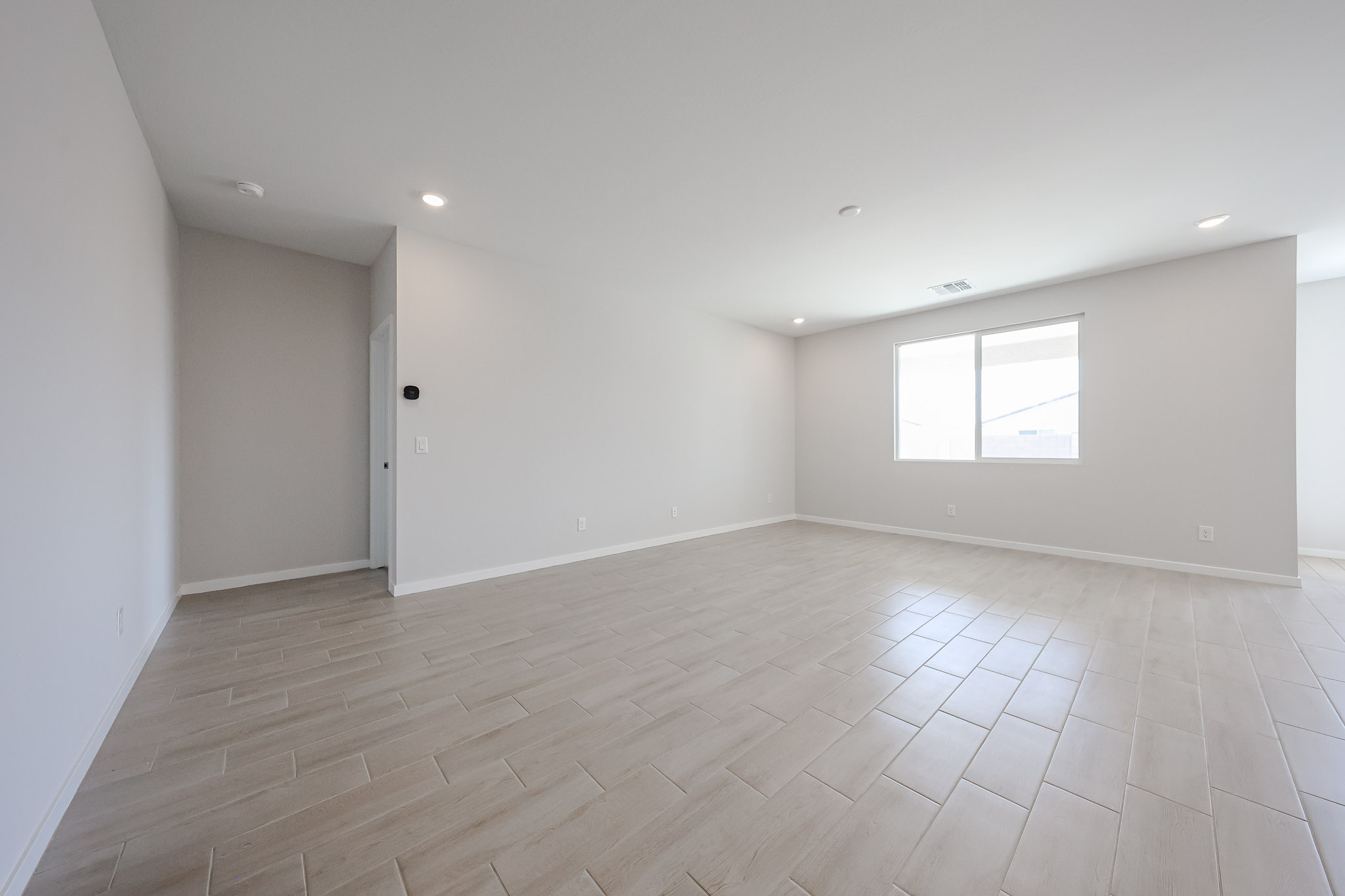 A room with a wood floor and white walls.