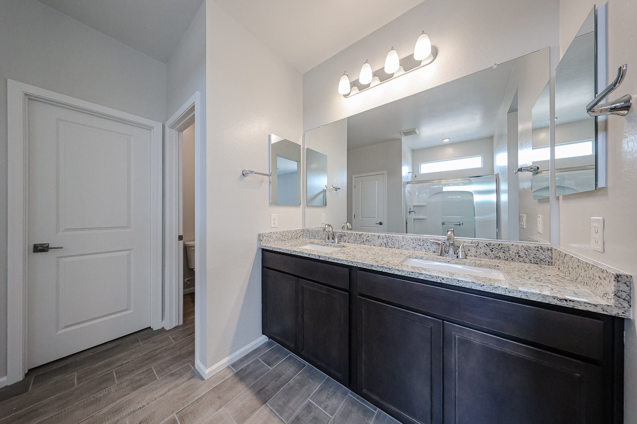 A bathroom with a large mirror.