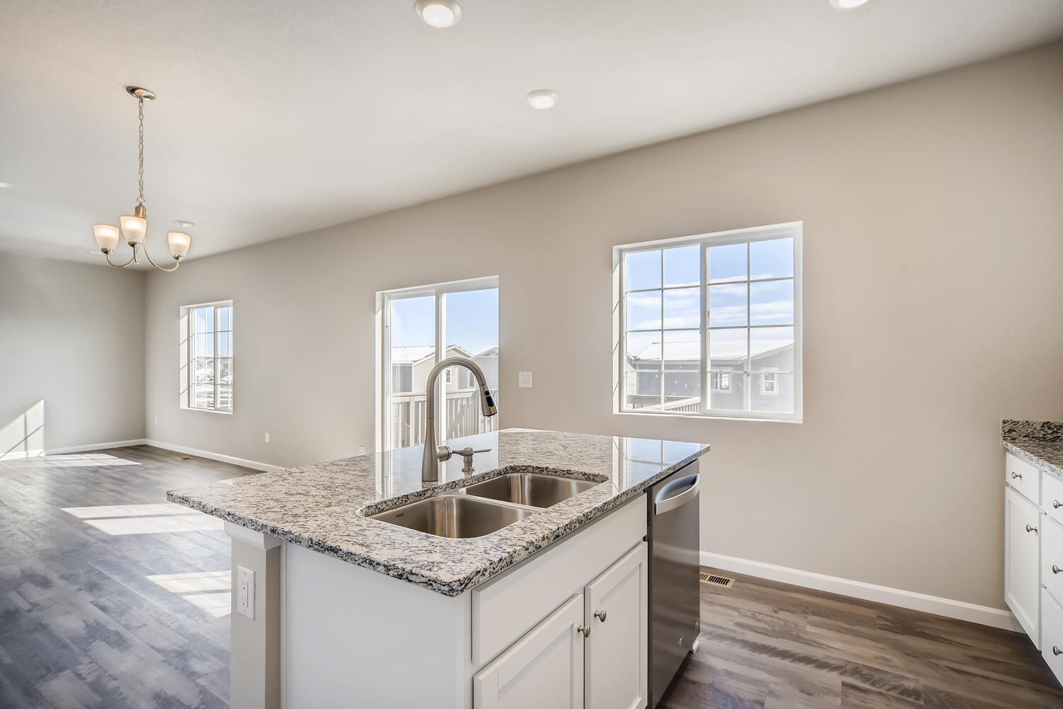 A kitchen with marble counters.