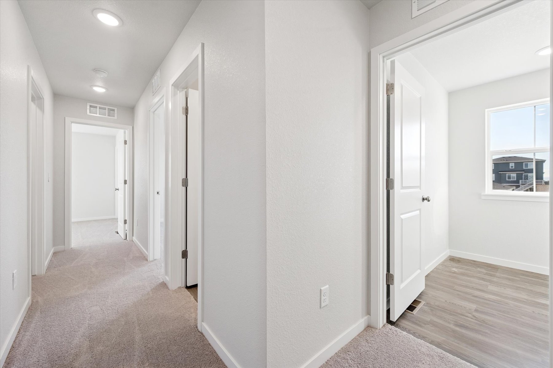 A hallway with white doors.