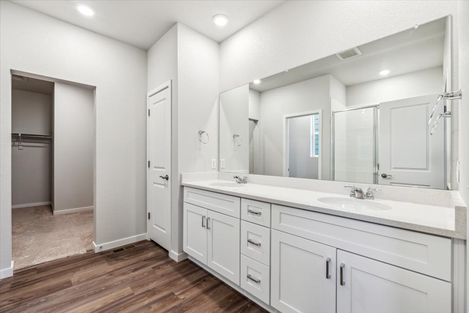 A bathroom with white cabinets.