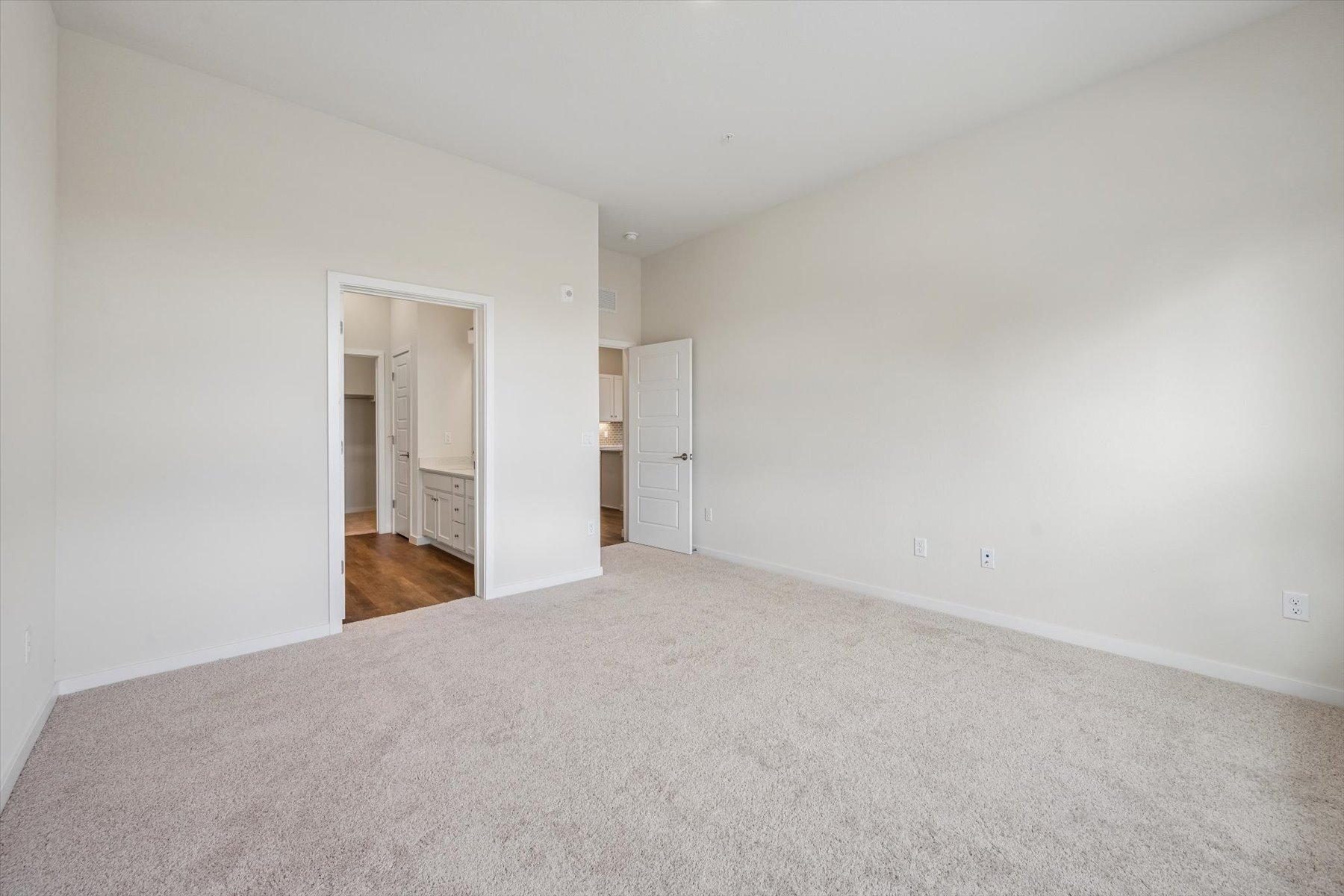 A hallway with white walls.