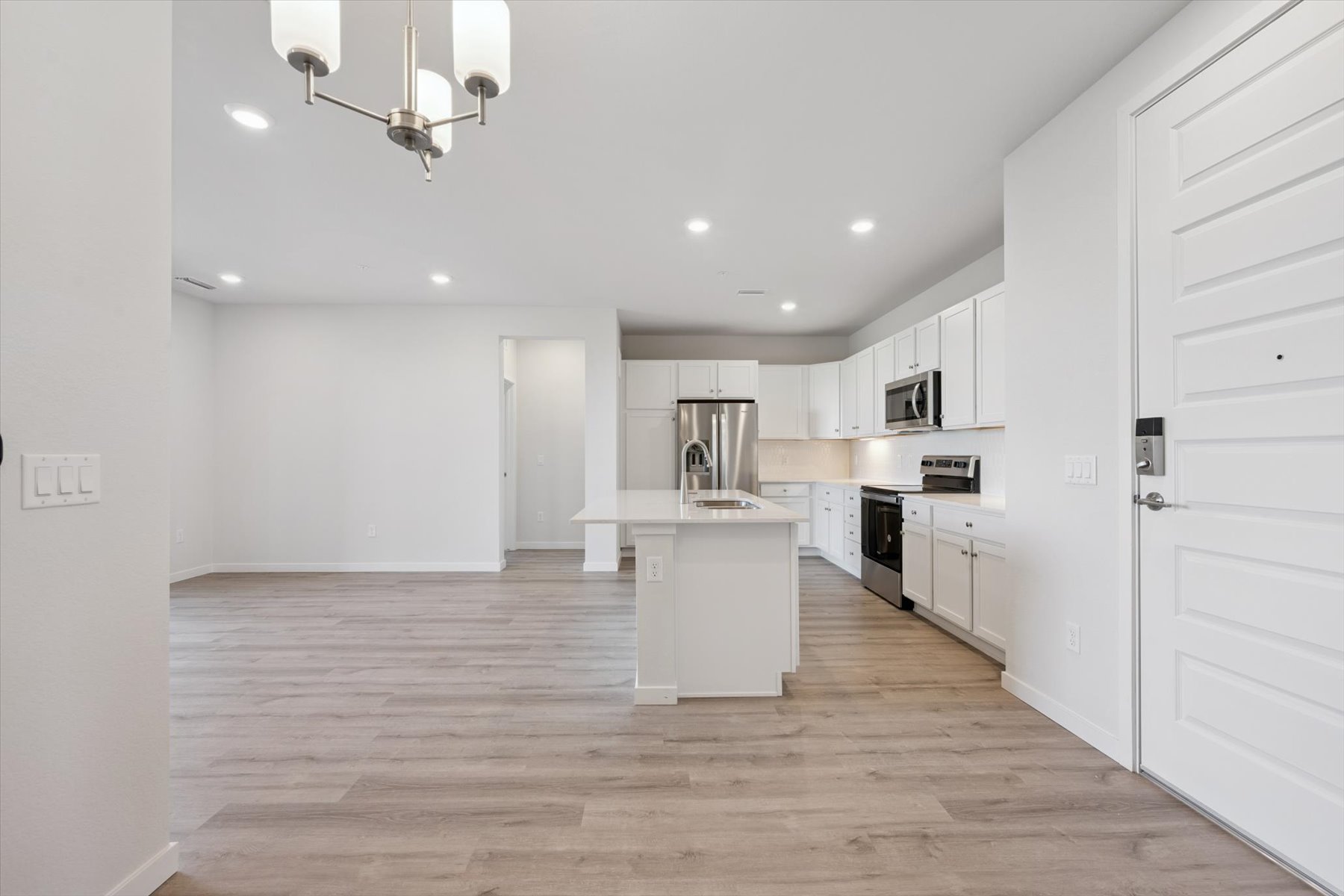 A kitchen with white cabinets.