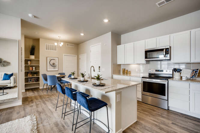 A kitchen with white cabinets.