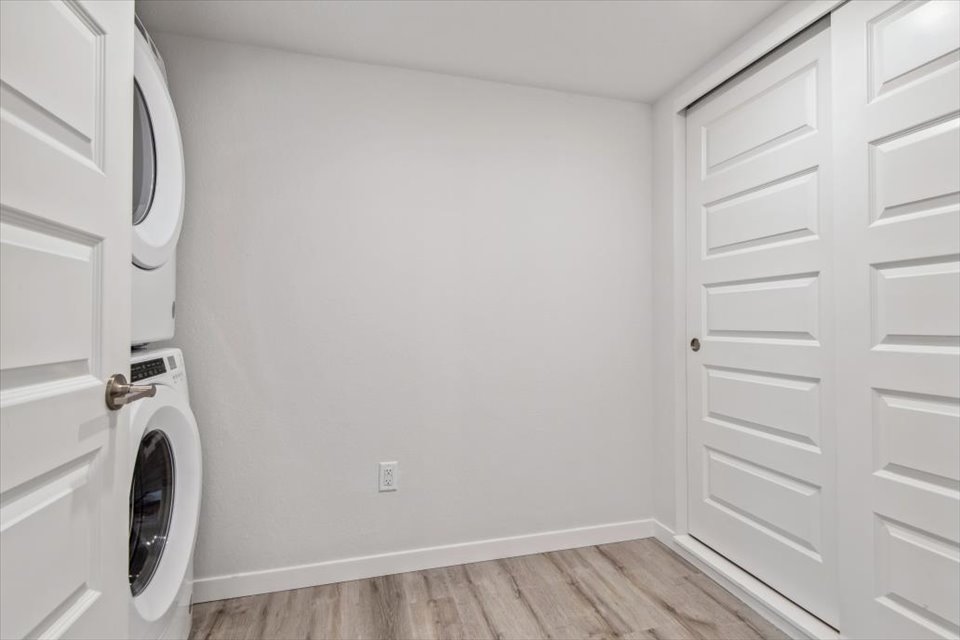 A white room with a washing machine.