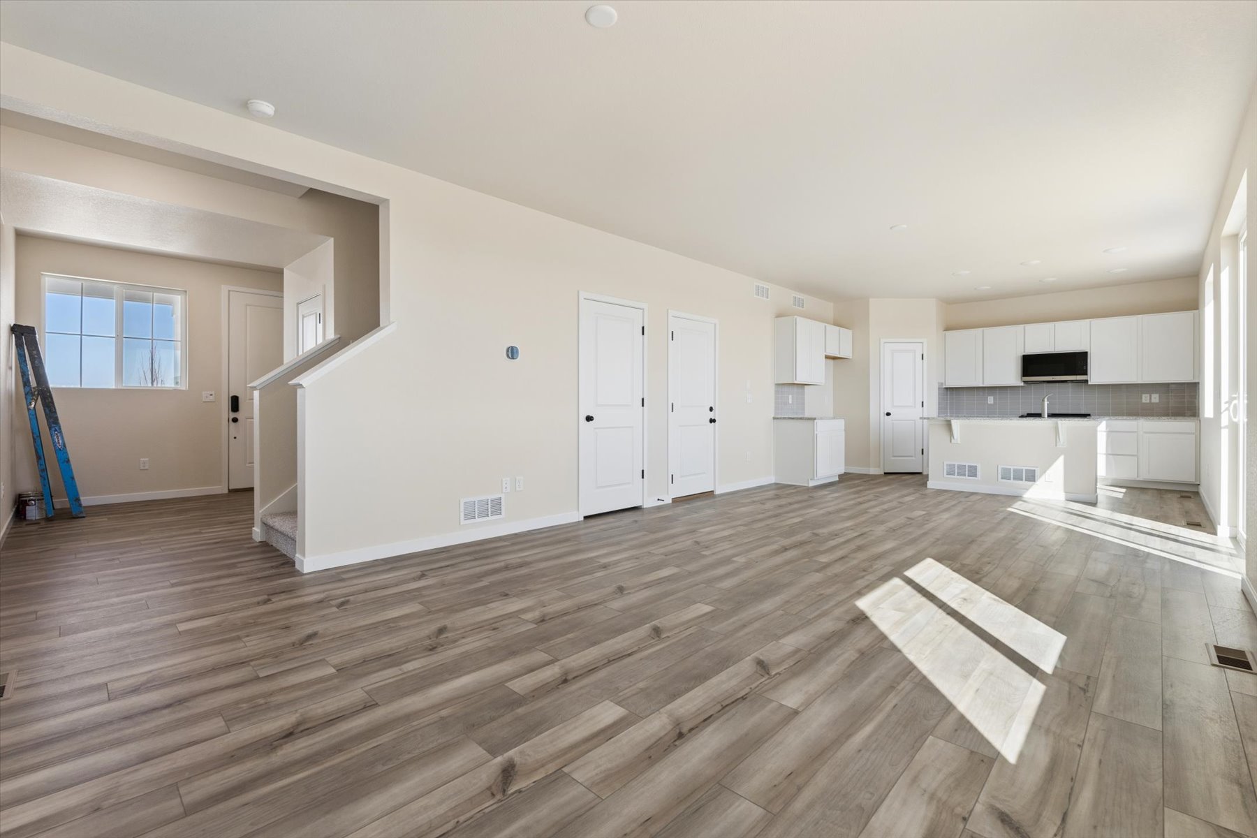 A room with white walls and wood floors.