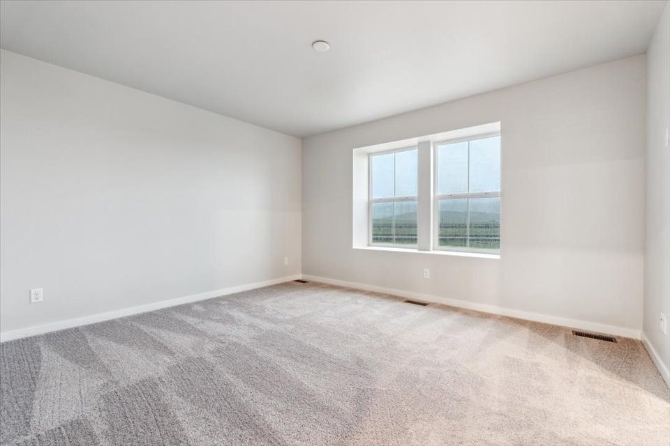 A room with a window and a carpet.