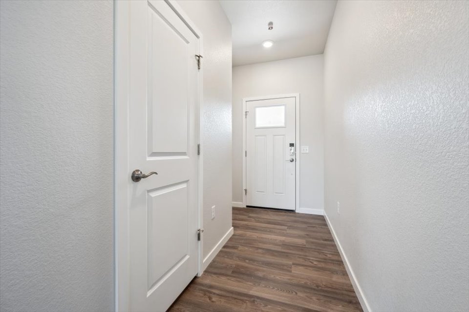 A hallway with white doors.