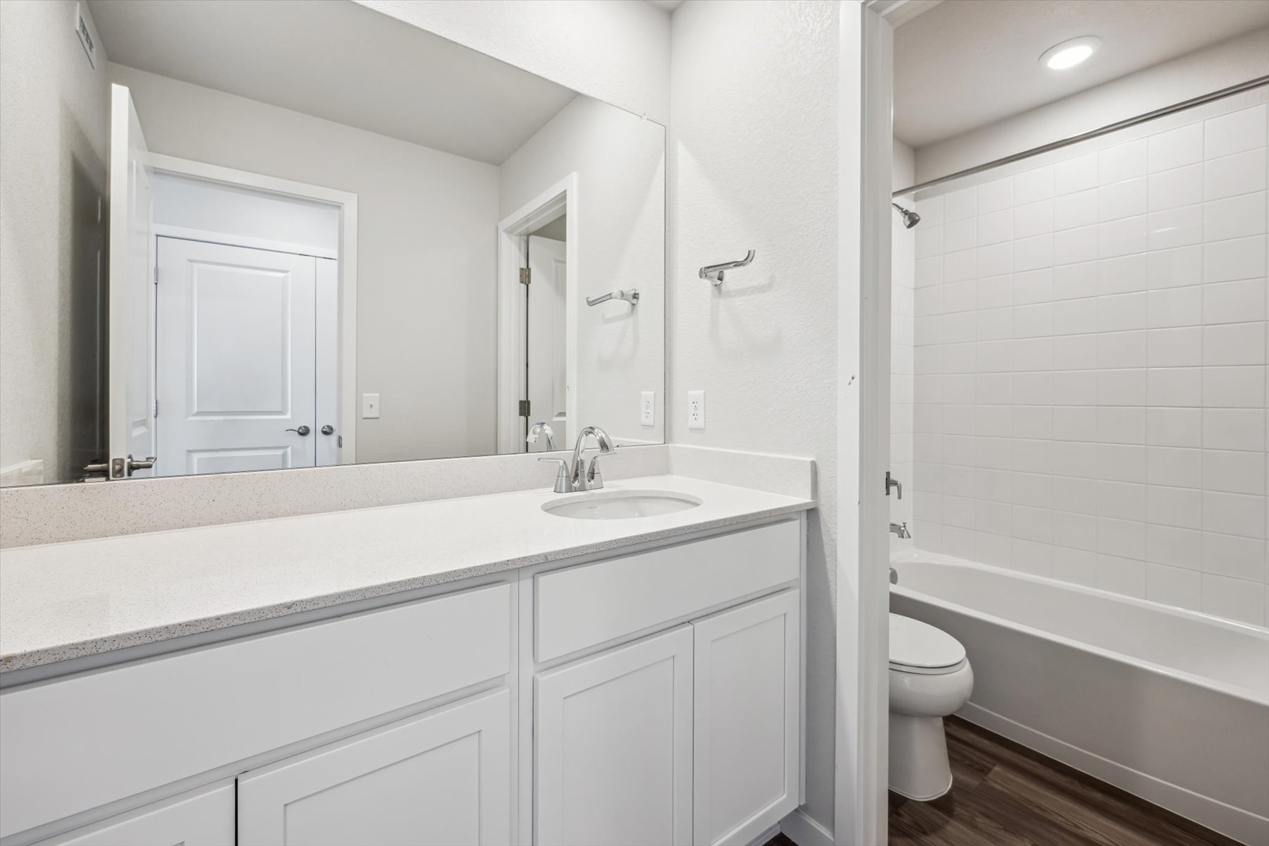 A bathroom with a tub sink and toilet.