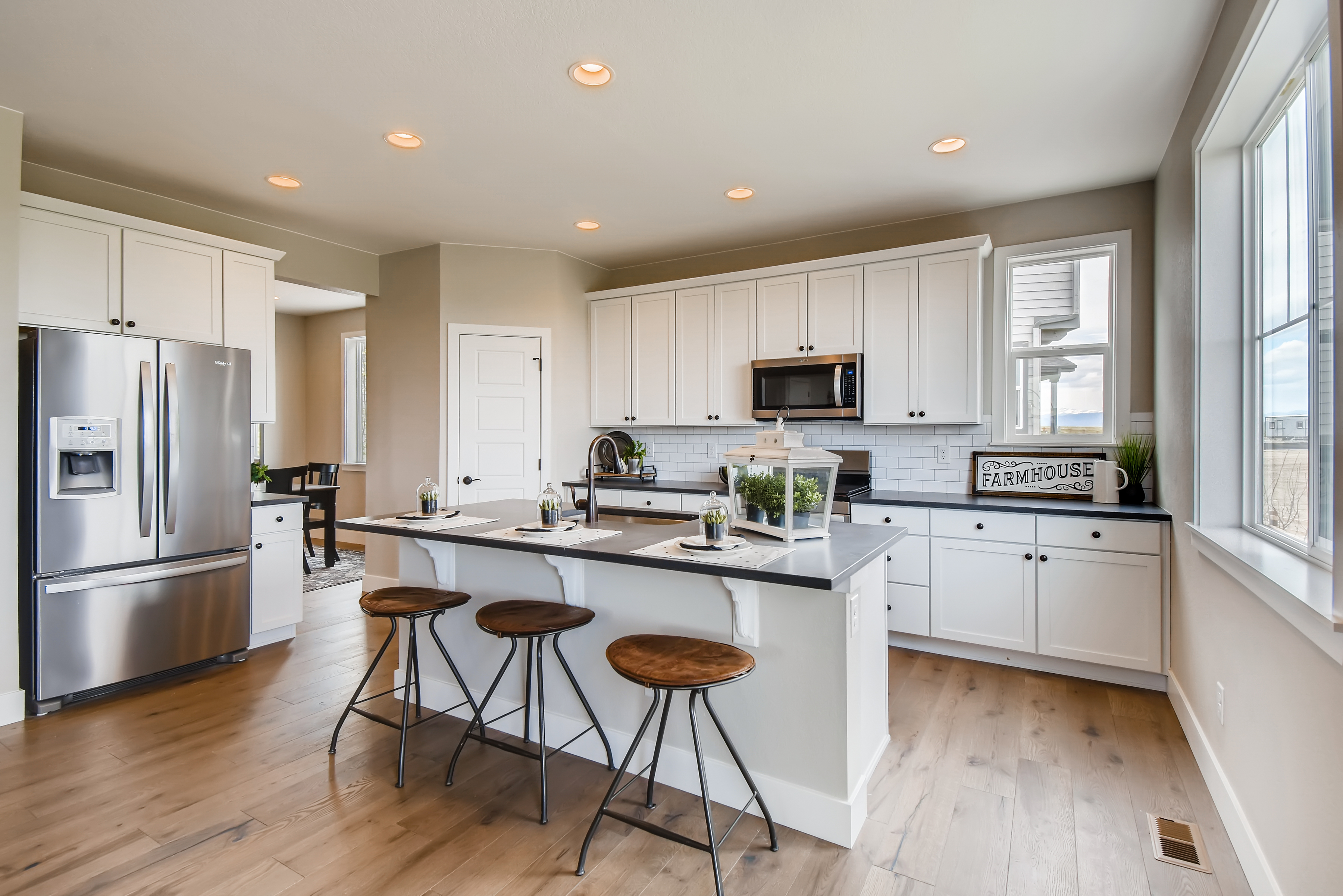 A kitchen with stools and a table.