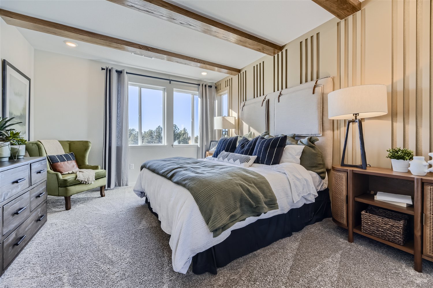 A bedroom with a bed and a chair.