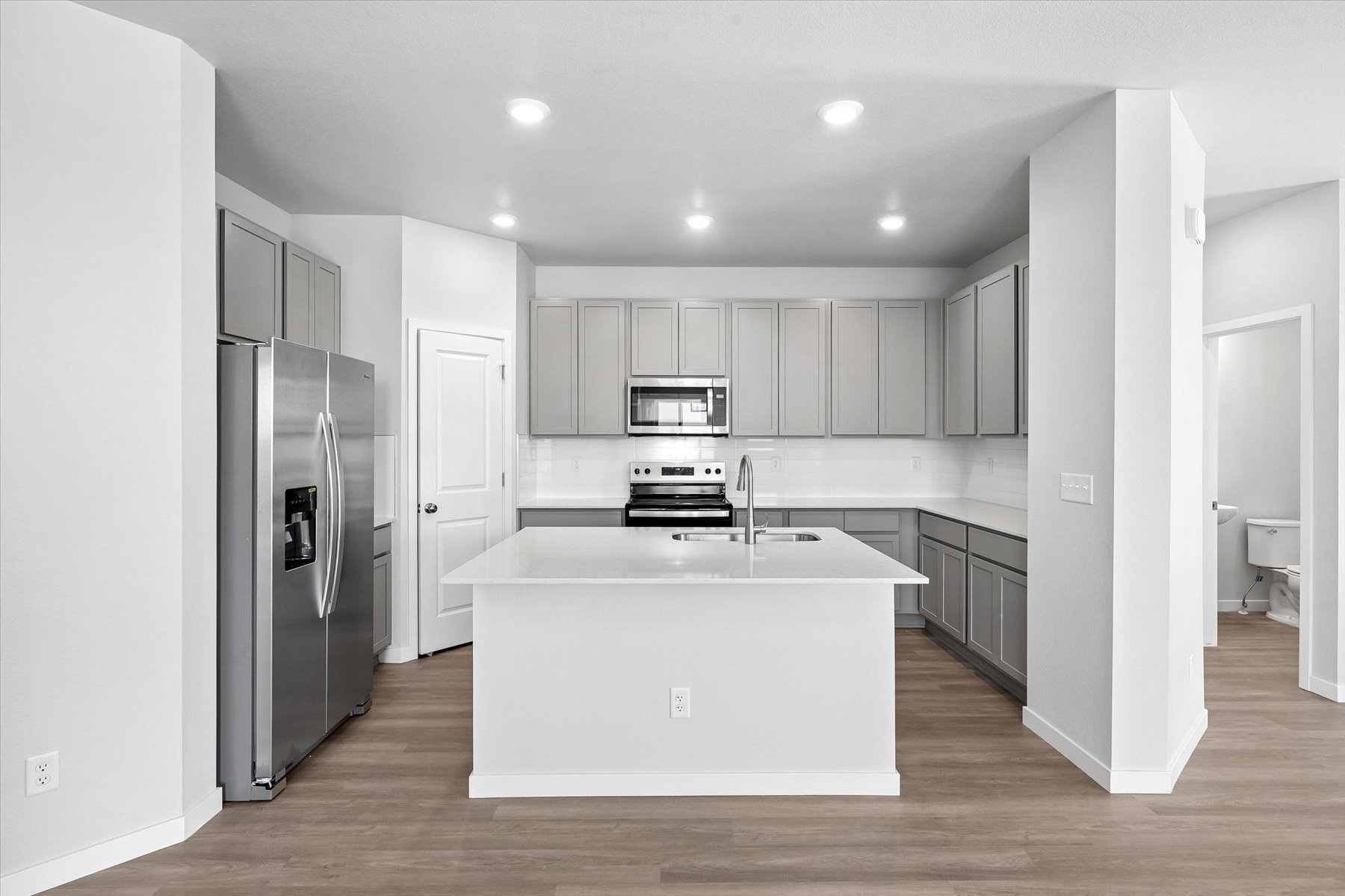 A kitchen with white cabinets.