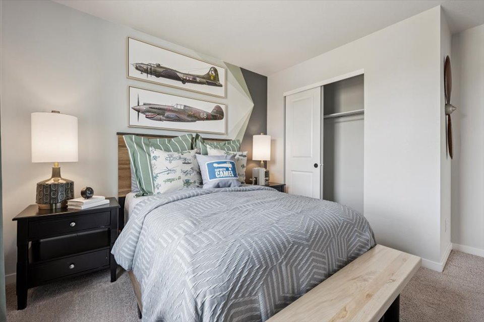 A bedroom with a bed and lamps.