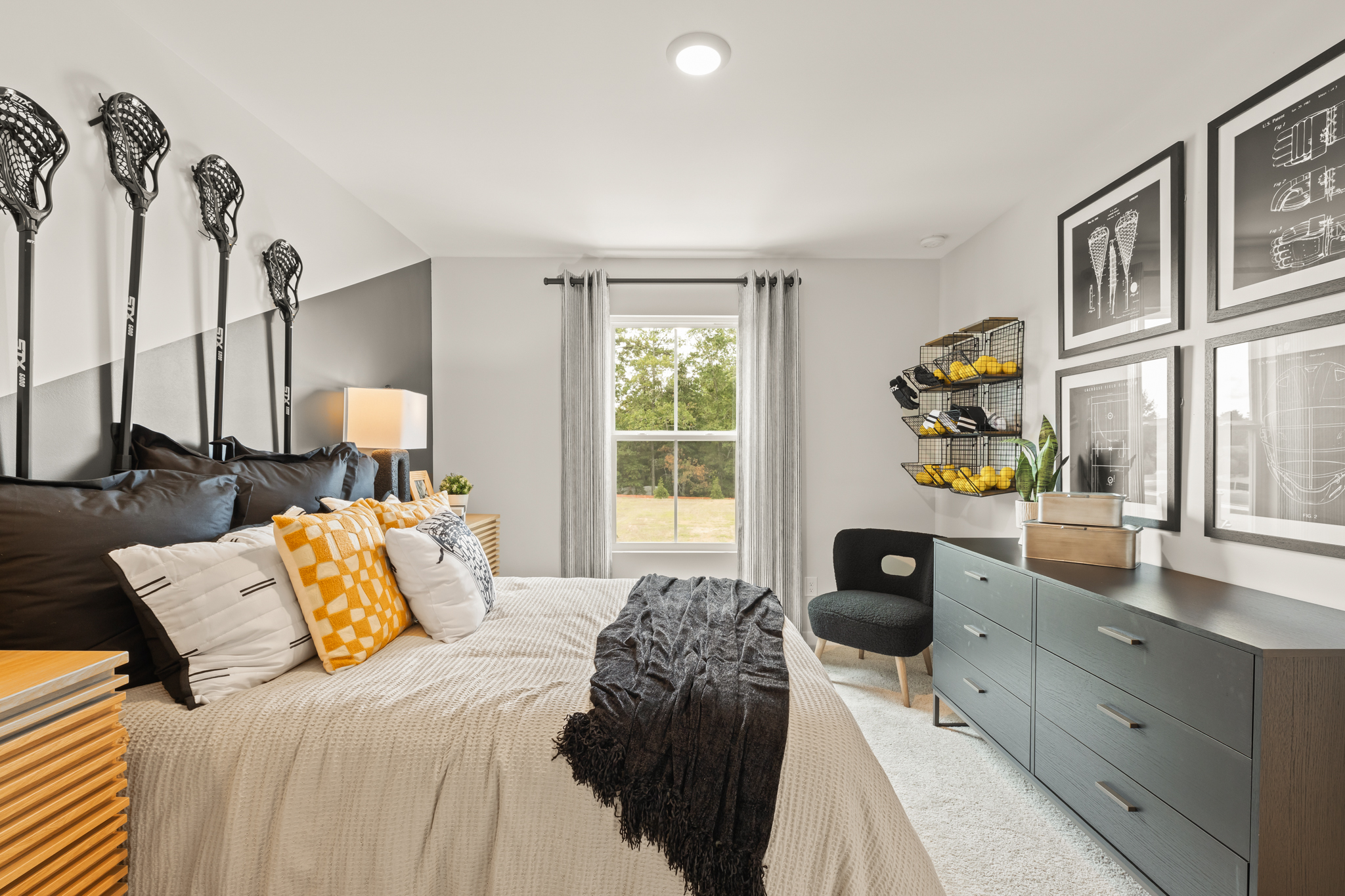 A bedroom with a bed and a chair.