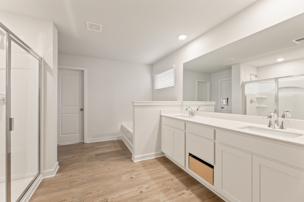A bathroom with white cabinets.