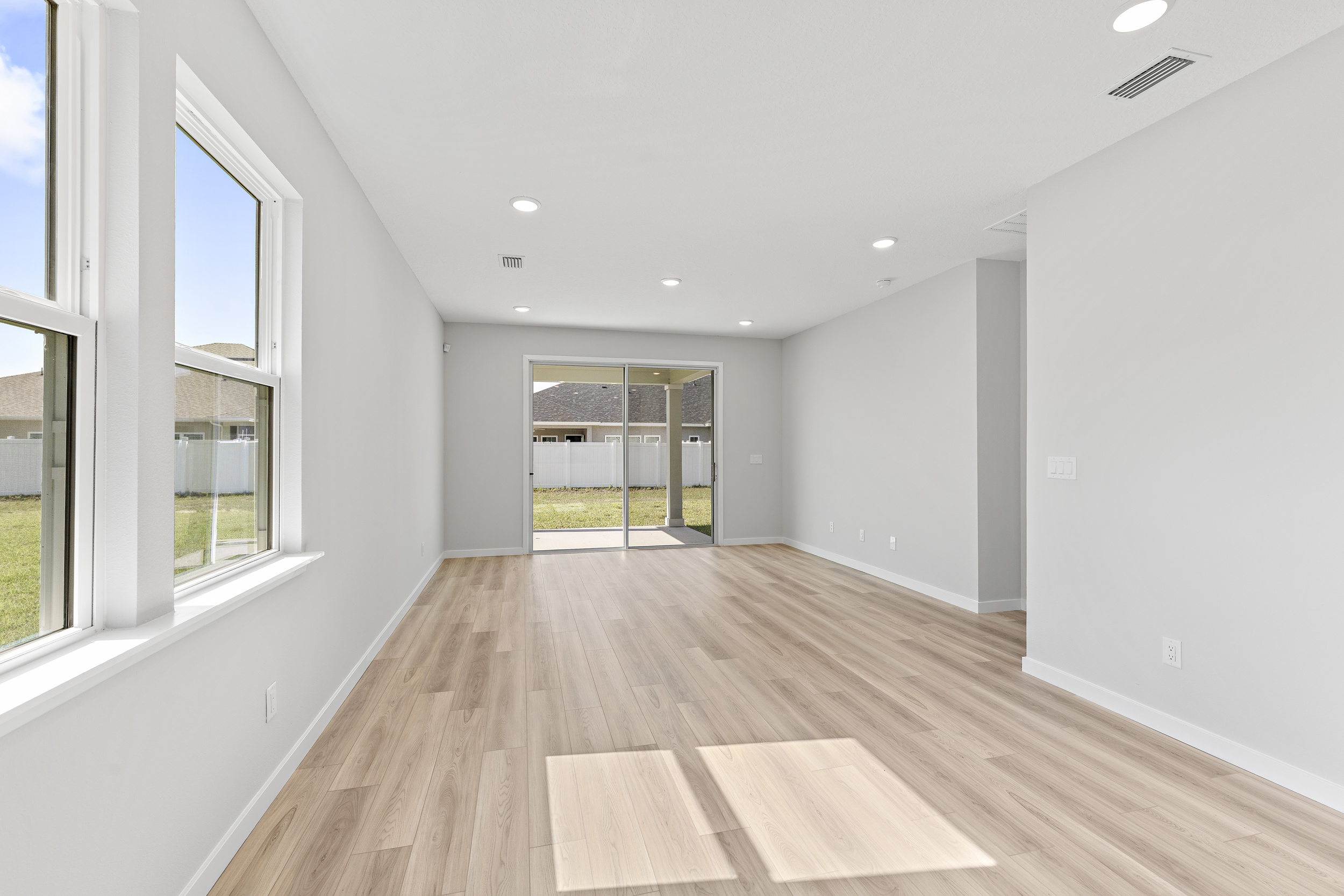 Open Dining Area with Light LVP Flooring in Lot 19 Cedar II at Camden Woods in Kingsland, GA