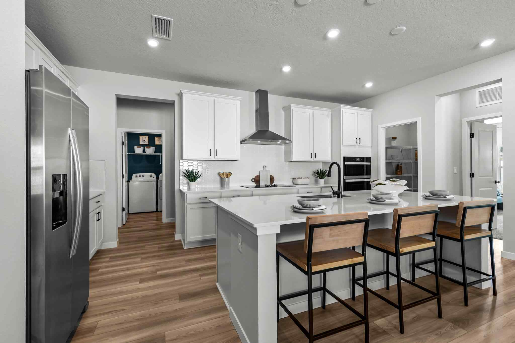A kitchen with white cabinets.