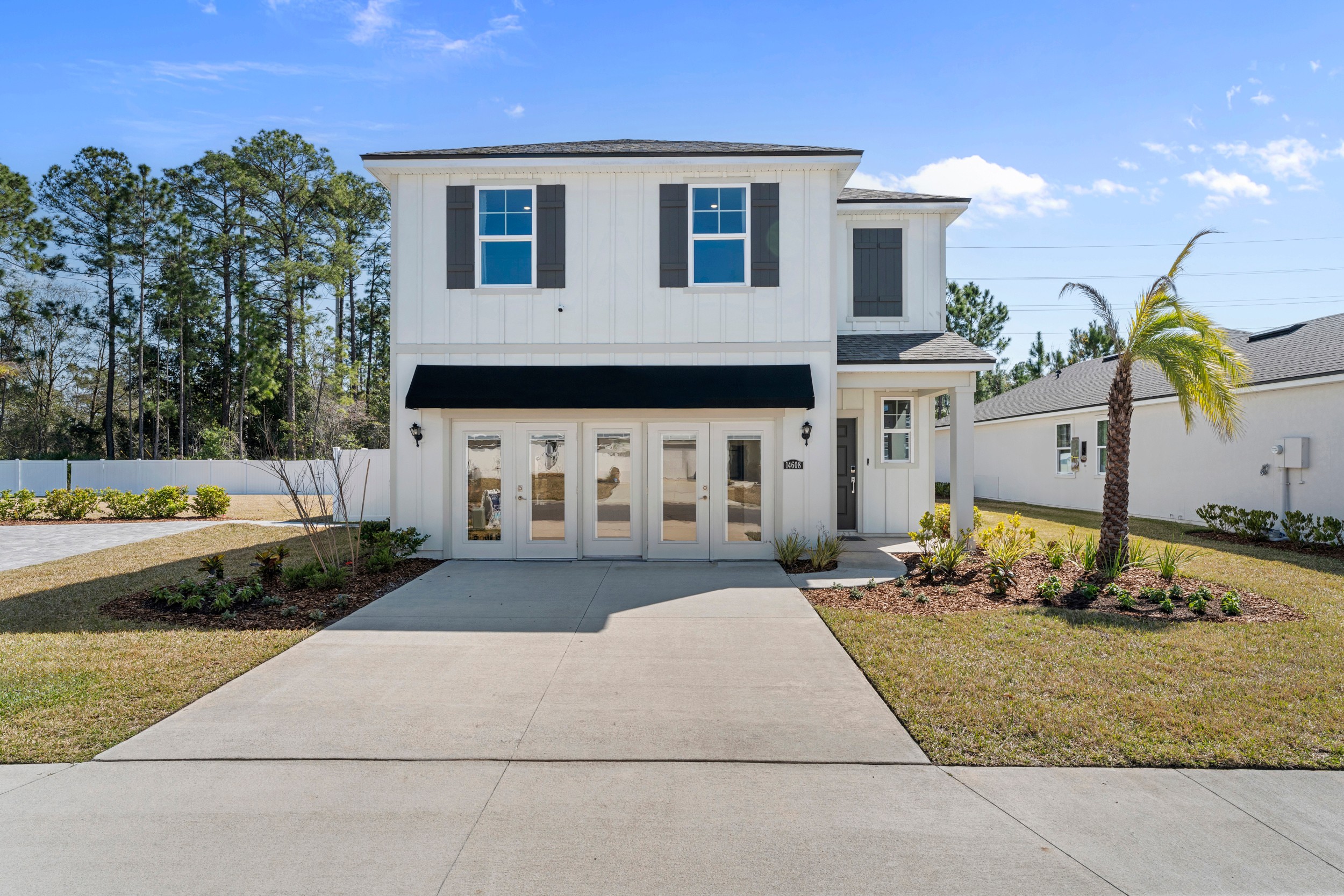A white house with a driveway.