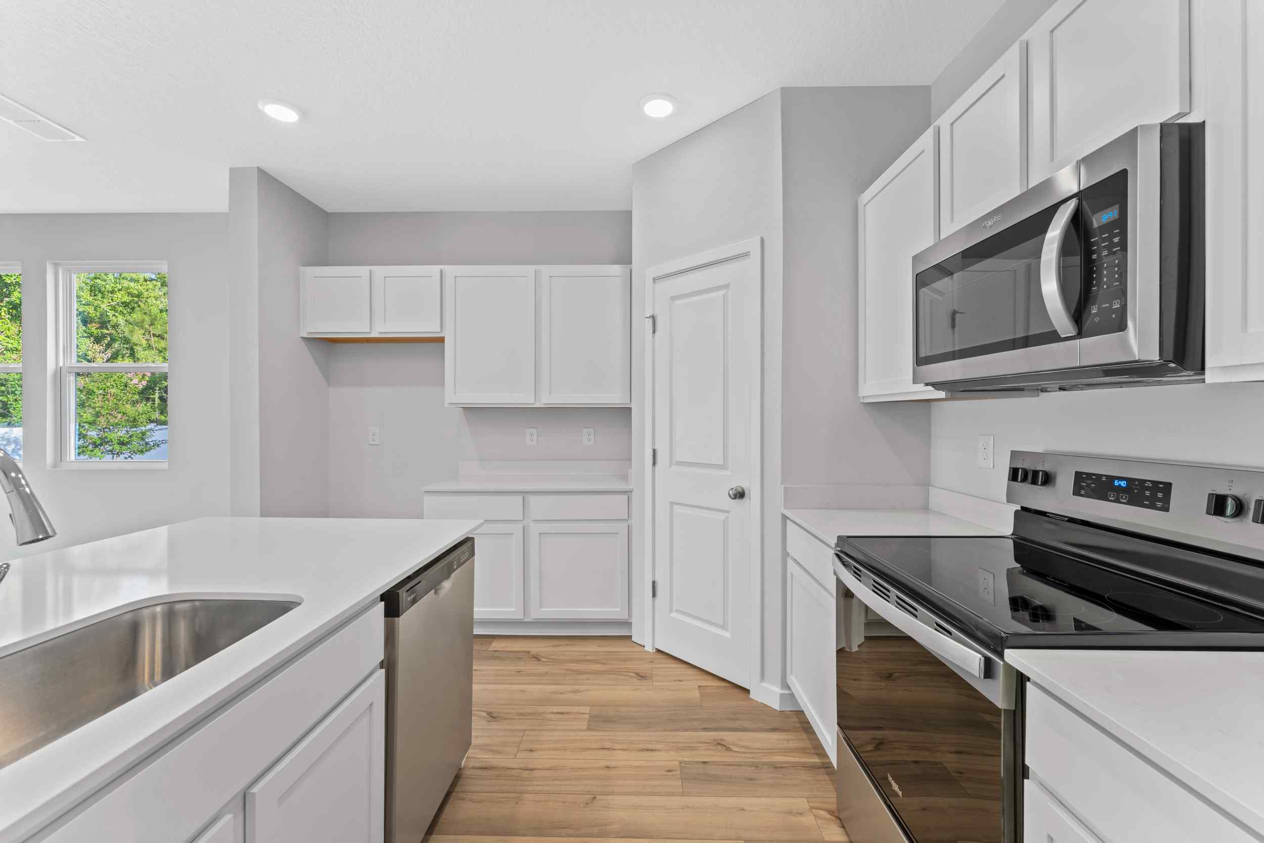 Davor Paired Home Kitchen with White Cabinets at The Landings at Pecan Park in Jacksonville