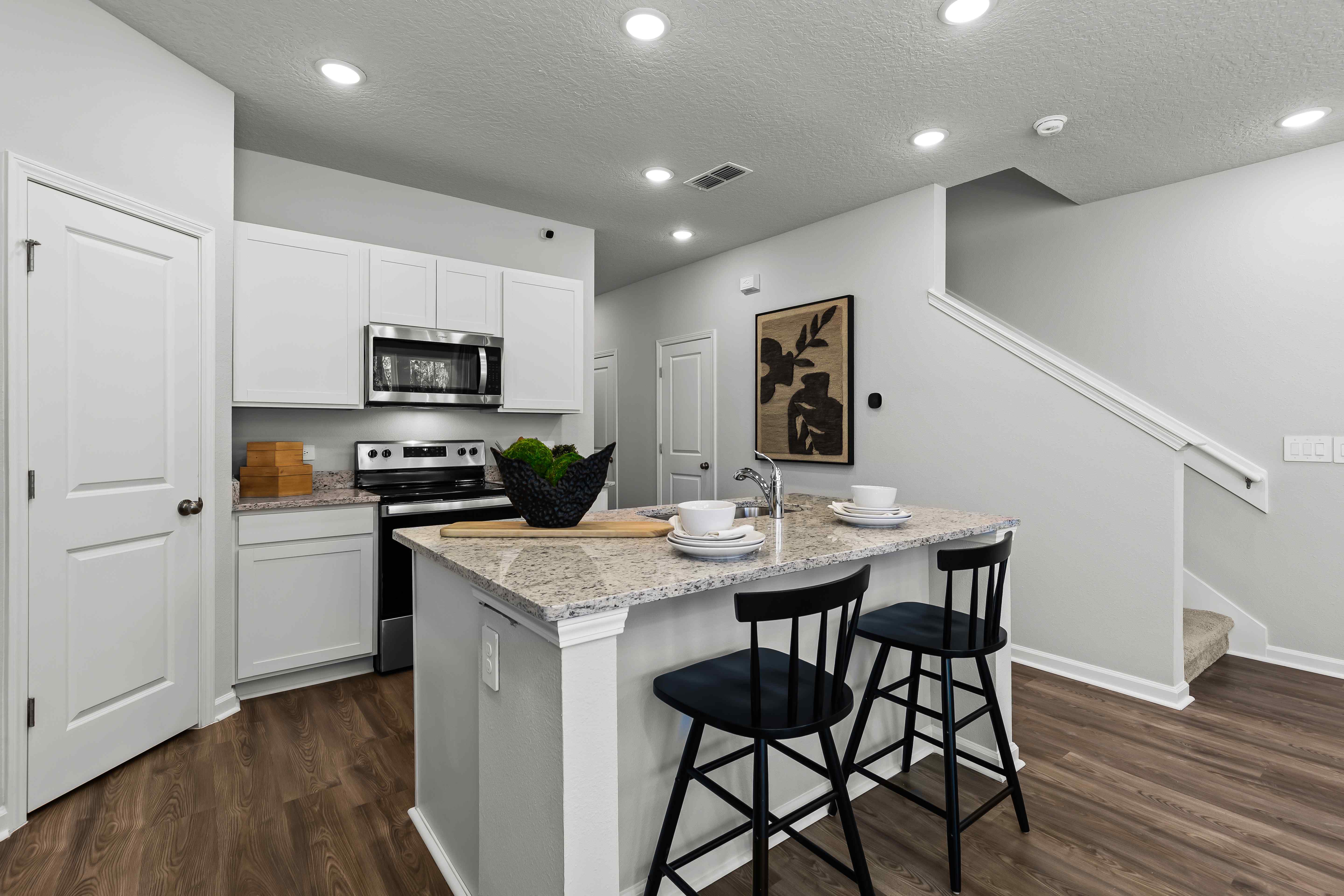 Davor Model Paired Home Kitchen with White Cabinets and Corner Pantry at The Landings at Pecan Park