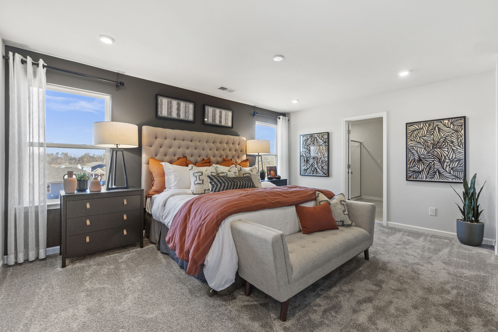 A bedroom with a bed and a couch.