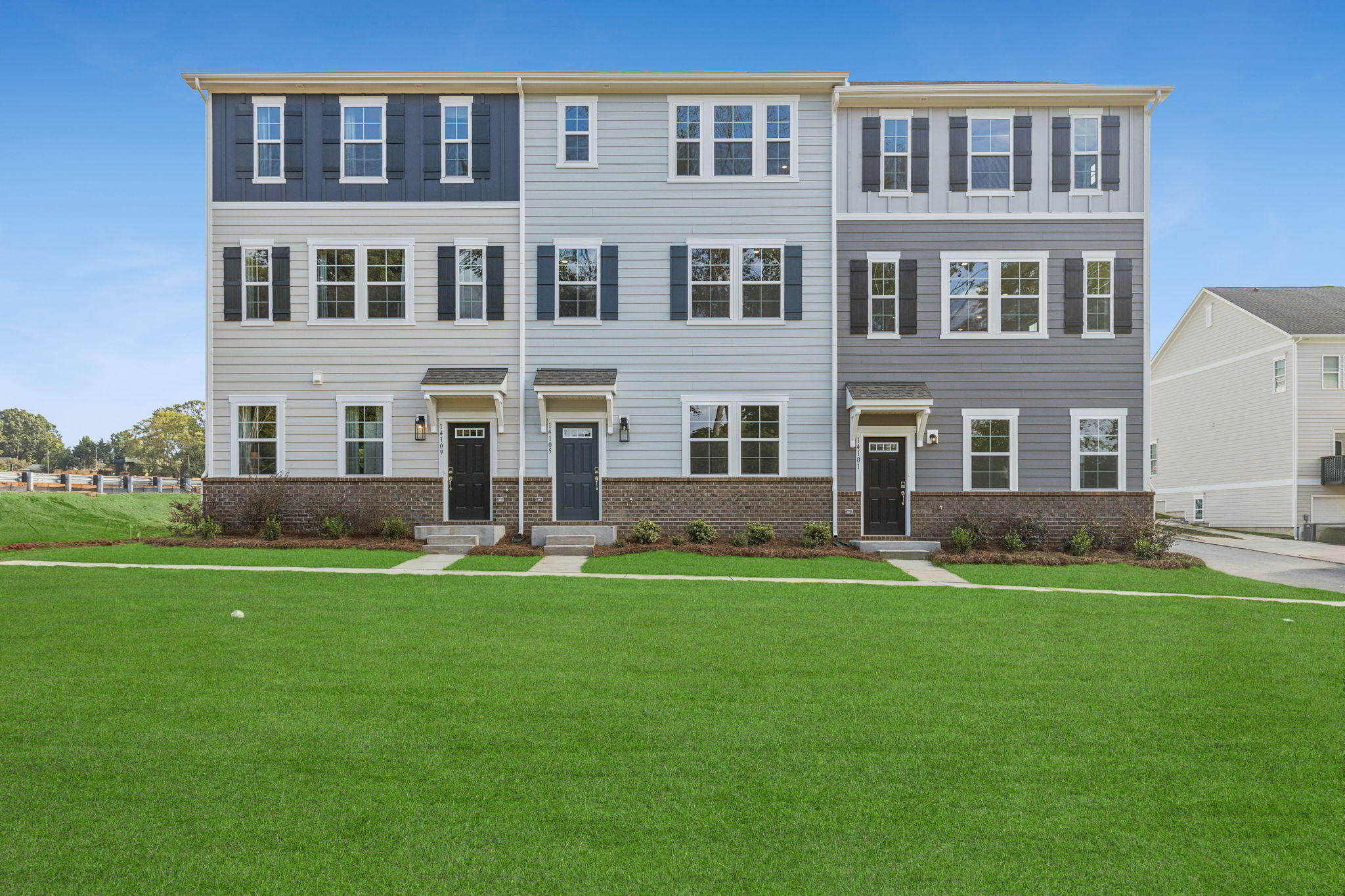 A large white building with a lawn in front of it.
